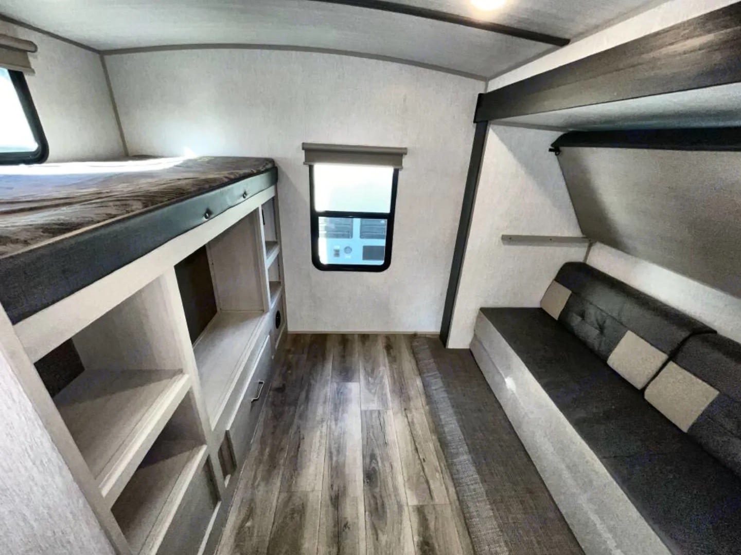 Inside an RV rental: bunk beds, sofa, window, and built-in storage. A functional and cozy travel space for adventures.. Forest River Salem Hemisphere 2023