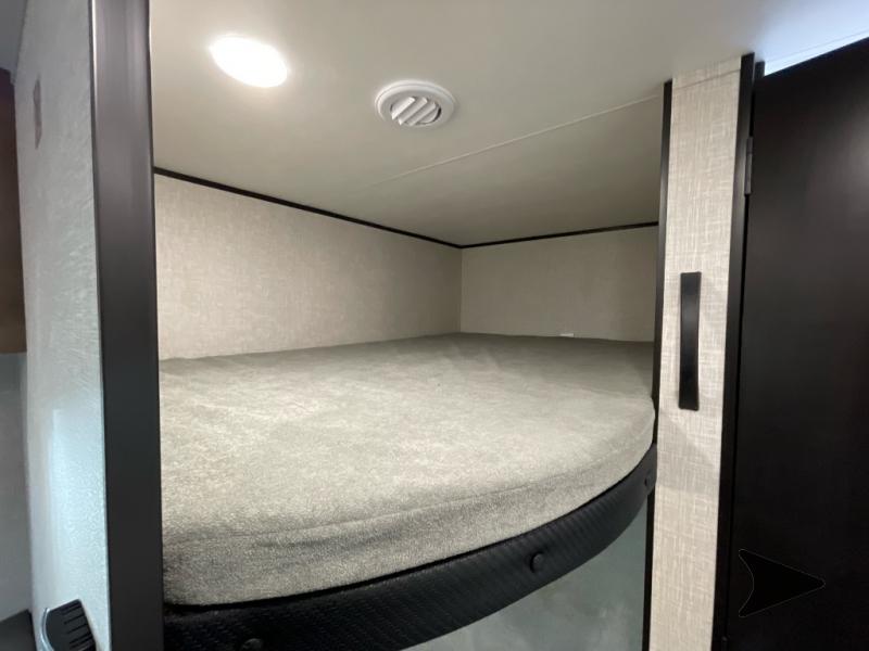 RV rental bunk bed with cozy mattress, overhead light, and AC vent for comfortable travel.. Jayco Jay Flight SLX 2025
