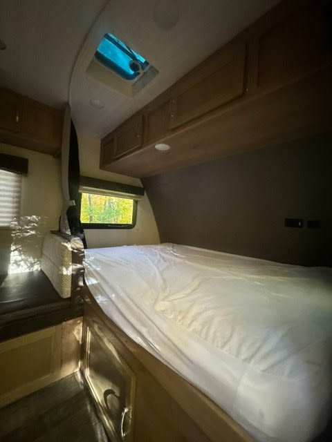 Cozy RV rental interior bedroom with a large bed, overhead storage, and skylight. Perfect for your adventure.. Winnebago Micro Minnie 2020