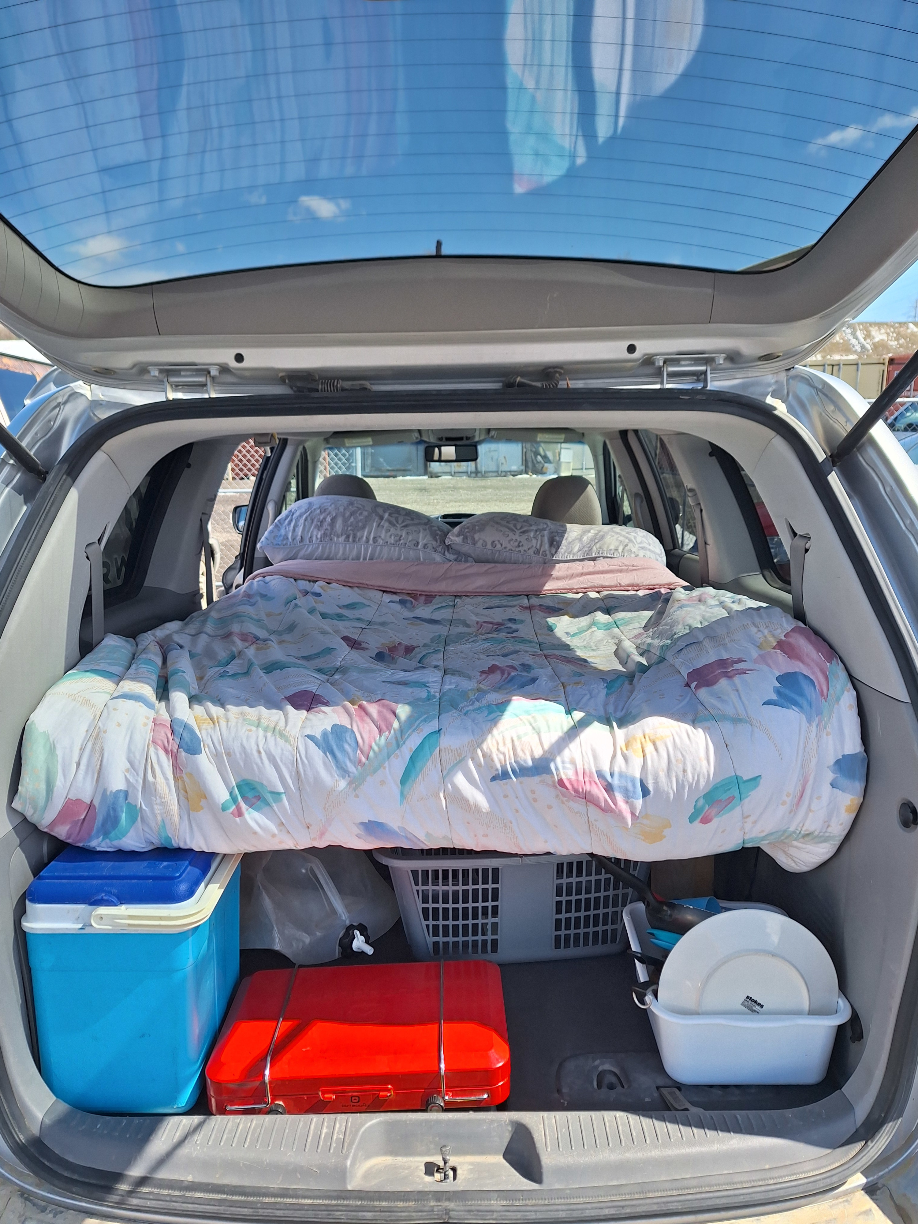 DIY car camping: a vehicle bed, cooler, and portable kitchen transform this car into a micro RV rental for adventure.. Glacier Campers Cosy CrewVan 2015