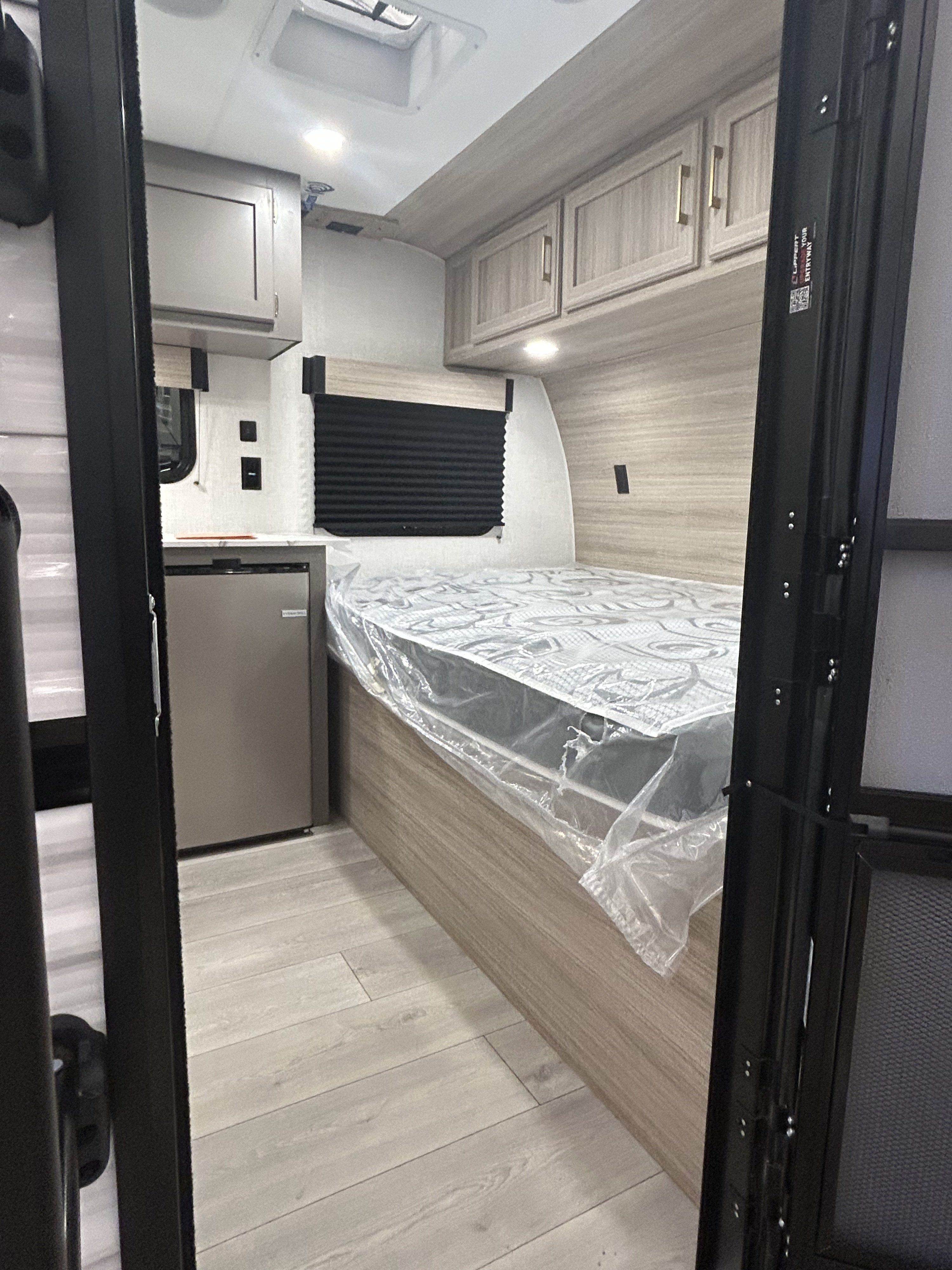 This rv rental features a compact interior with a bed, mini-fridge, and overhead storage. Perfect for road trips and travel.. K-Z 130RD 2026