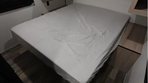 Clean bed inside an RV rental bedroom, ready for a comfortable stay.. Highland Ridge Open Range Colt 28DBS 2026