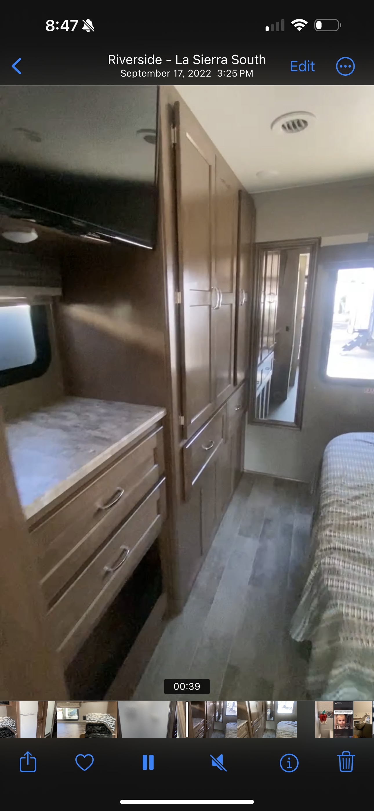 This RV rental offers a comfortable bedroom with ample storage, featuring a bed, wood cabinetry, and a television.. Winnebago Intent 2019