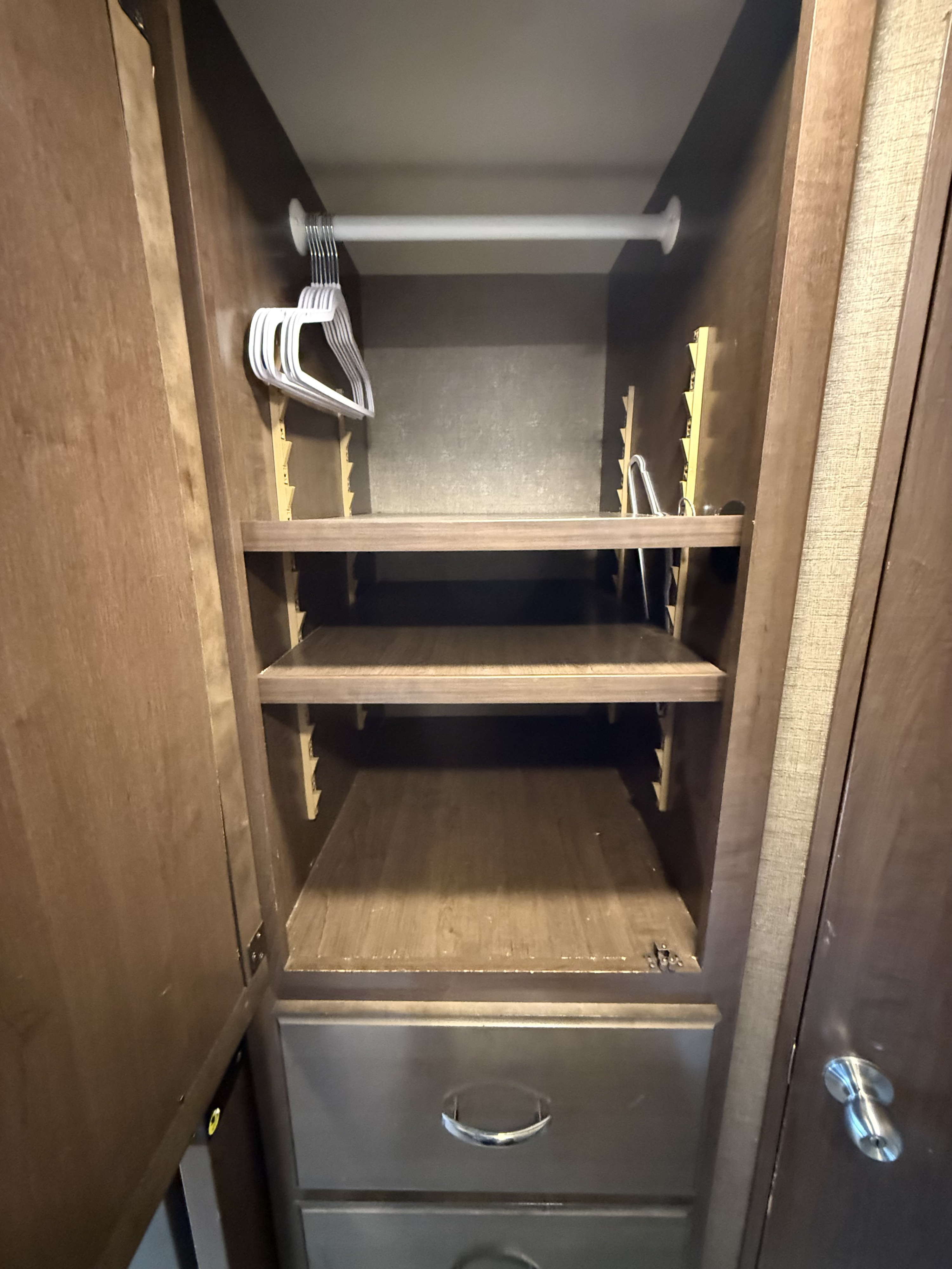 RV rental's compact closet features a hanging rod with hangers, adjustable shelves, and two drawers for efficient storage.. Thor Vegas 2017