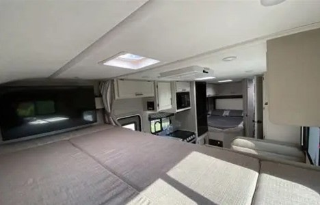 Inside this rv rental: spacious sleeping areas, a well-equipped kitchen, and cozy living space for comfortable travels.. Thor Freedom Elite 2022