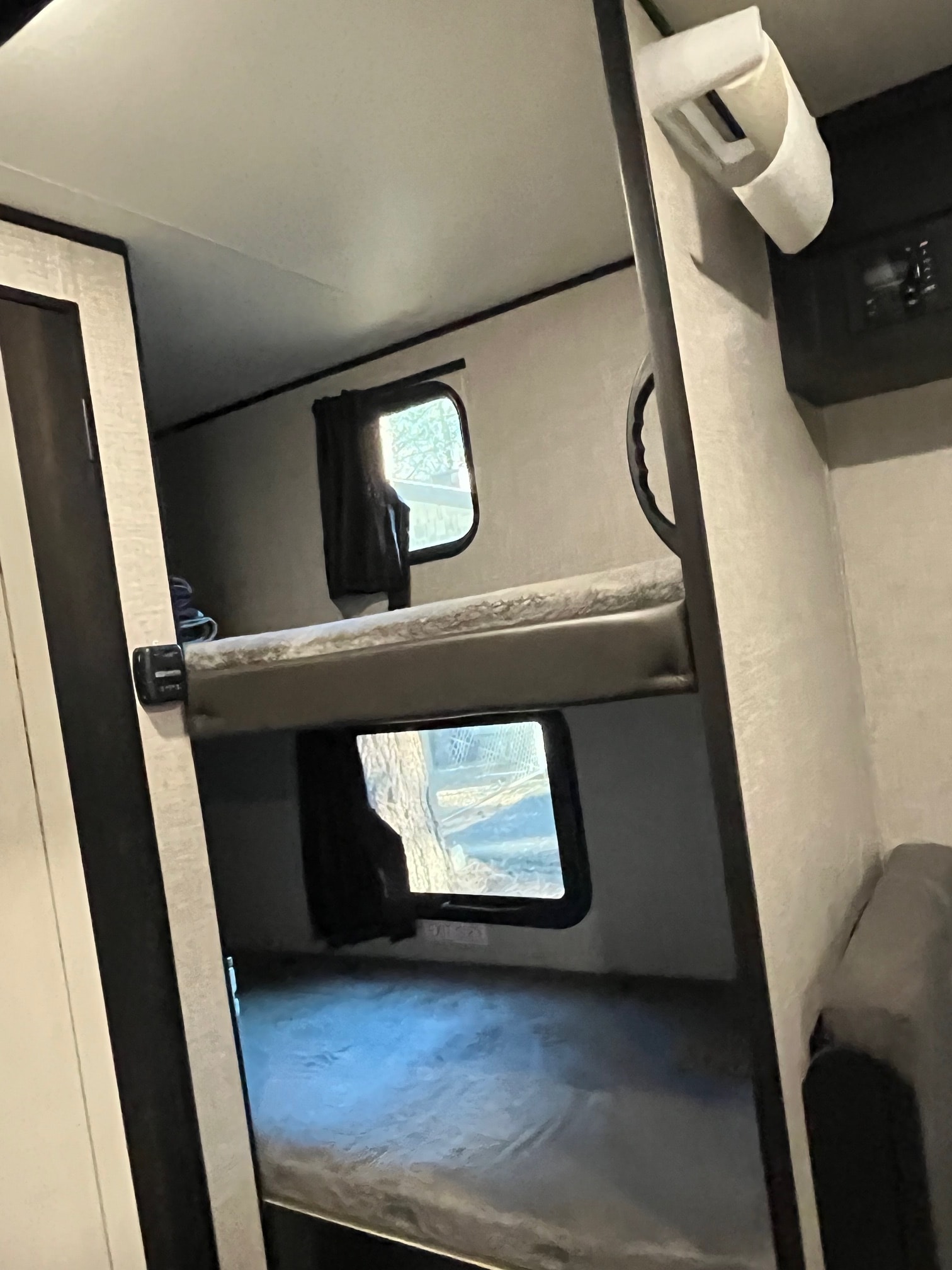 RV rental interior showing comfortable bunk beds with windows, perfect for travel accommodations.. Jayco Jay Flight SLX Baja Edition 2022
