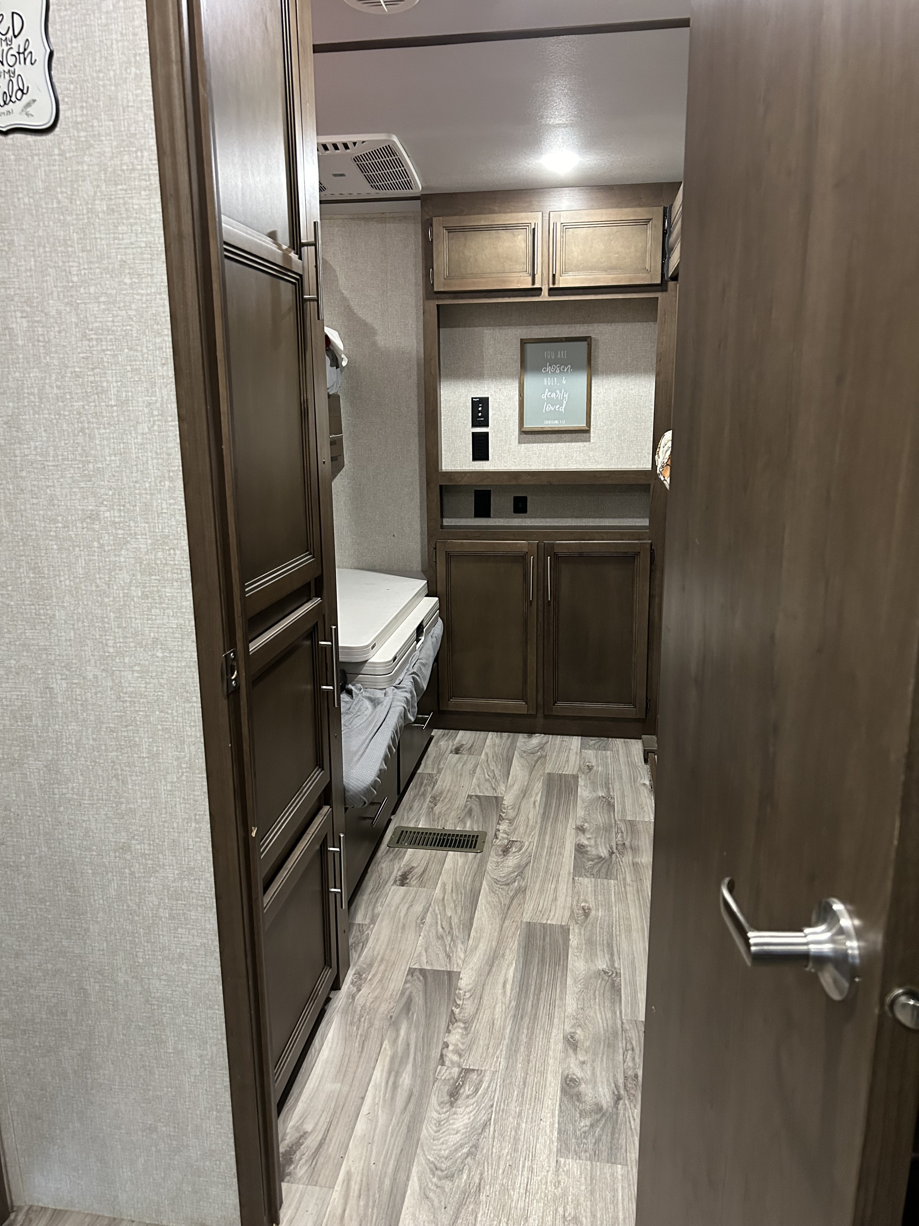 RV rental interior: hallway with bunk beds, stylish cabinets, and modern flooring. A welcoming, functional camper space.. Keystone RV Cougar 2021