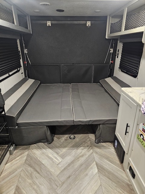 This rv rental features a versatile interior with a comfortable convertible bed/sofa, mesh overhead storage, and herringbone floor.. Forest River Salem 2022
