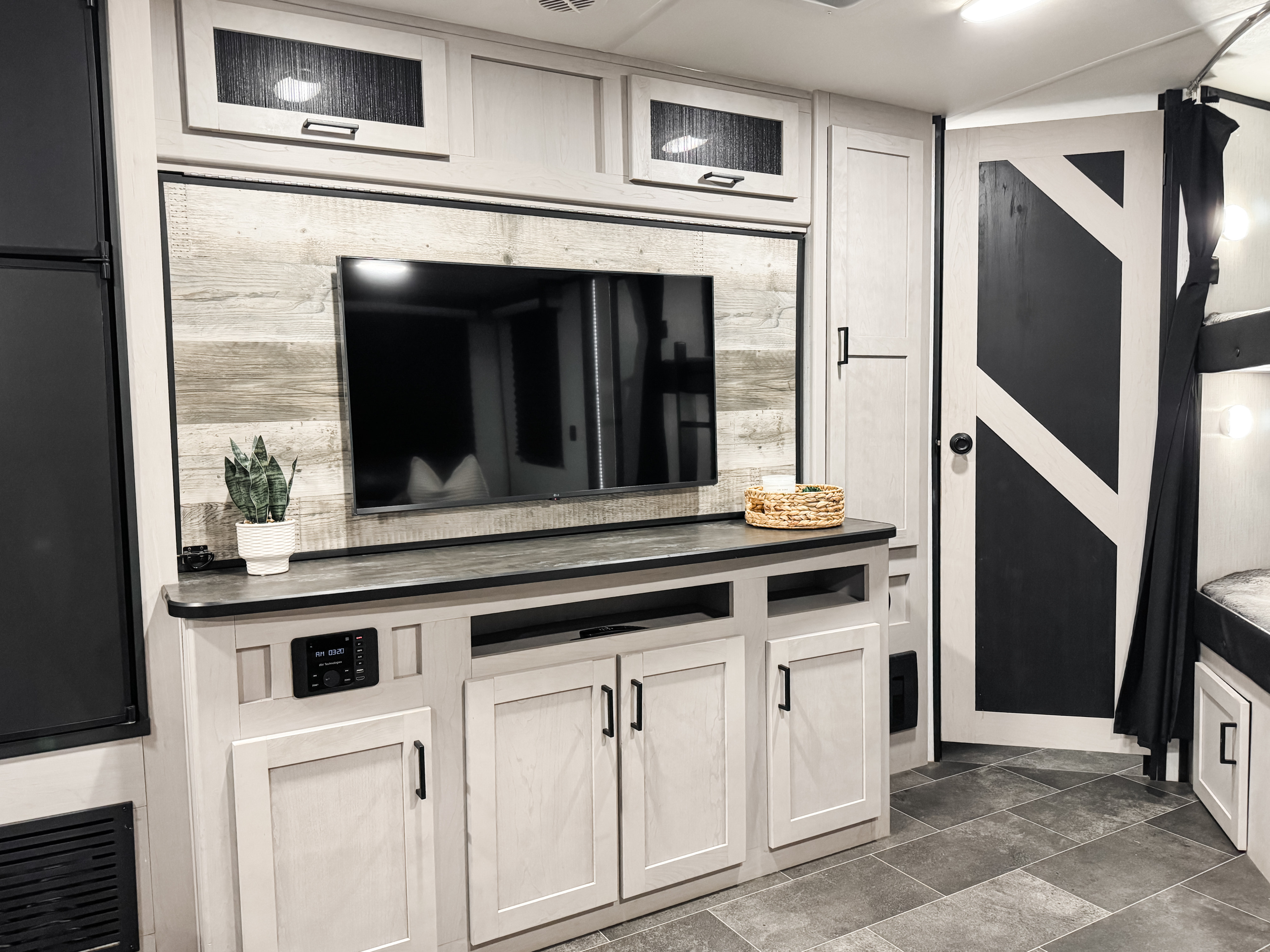 Step inside this modern RV rental with a stylish TV console, bunk beds, and barn door. Enjoy the light wood & black interior details.. Heartland Mallard M312 2022