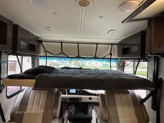 This RV rental features a cozy drop-down bunk bed above the front cabin seats & dashboard, offering extra sleeping space.. Holiday Rambler Admiral 2022