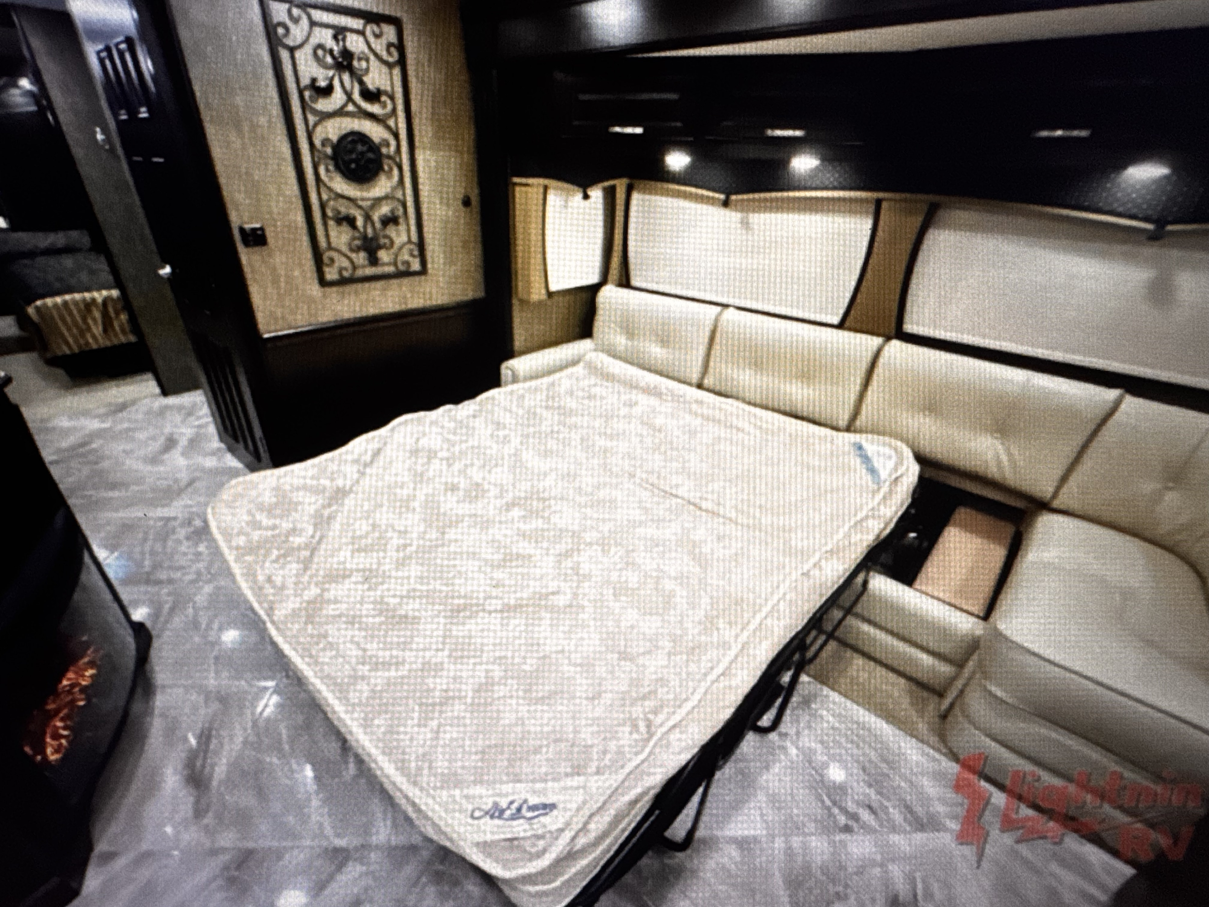 Modern RV rental living area with an extended pull-out bed and plush L-shaped sofa, ideal for relaxing during your travels.. Berkshire XLT 2016