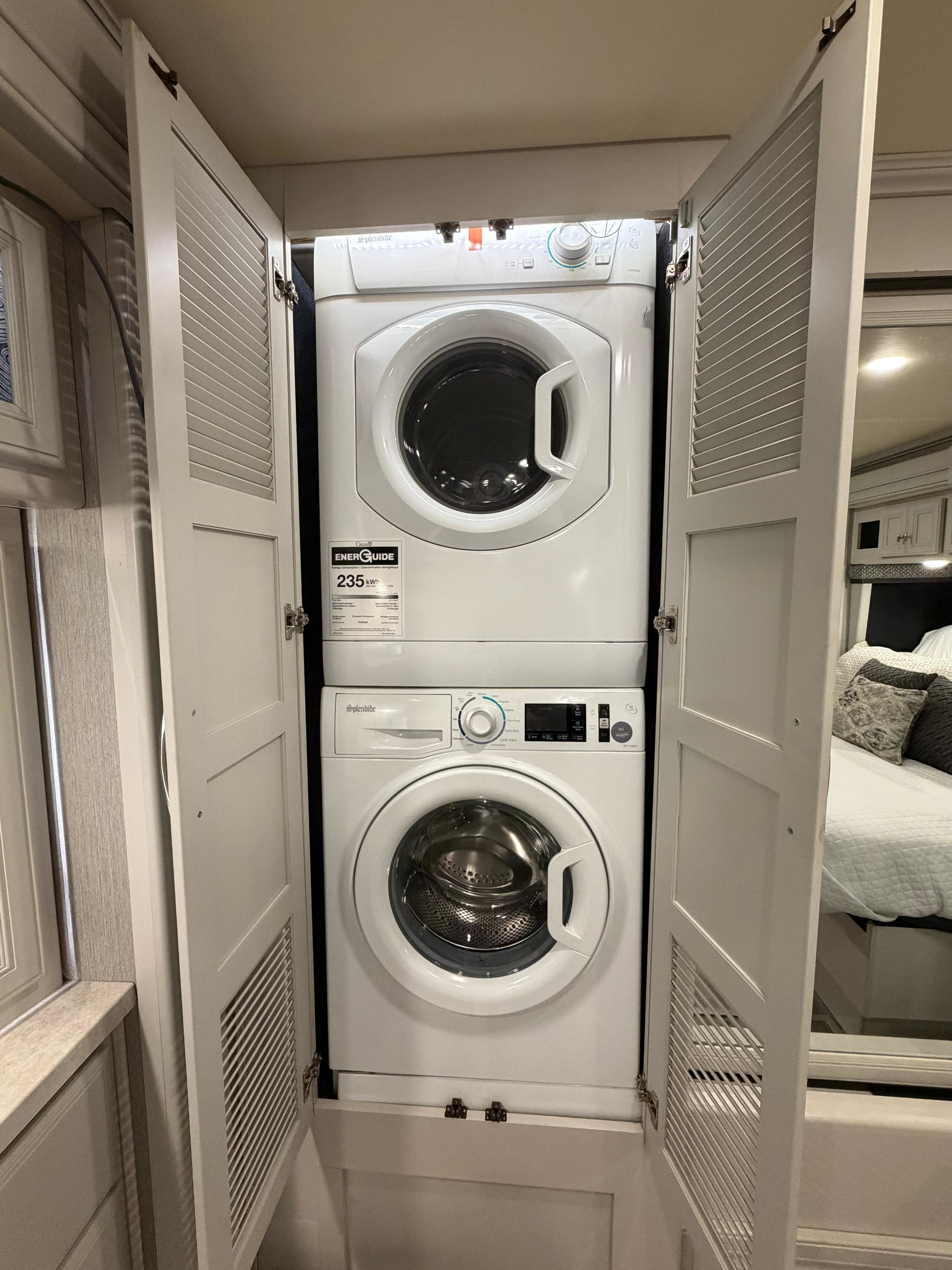 Stackable Splendide washer & dryer in an RV rental closet. Compact laundry solution for on-the-go travel.. Holiday Rambler Nautica 2021