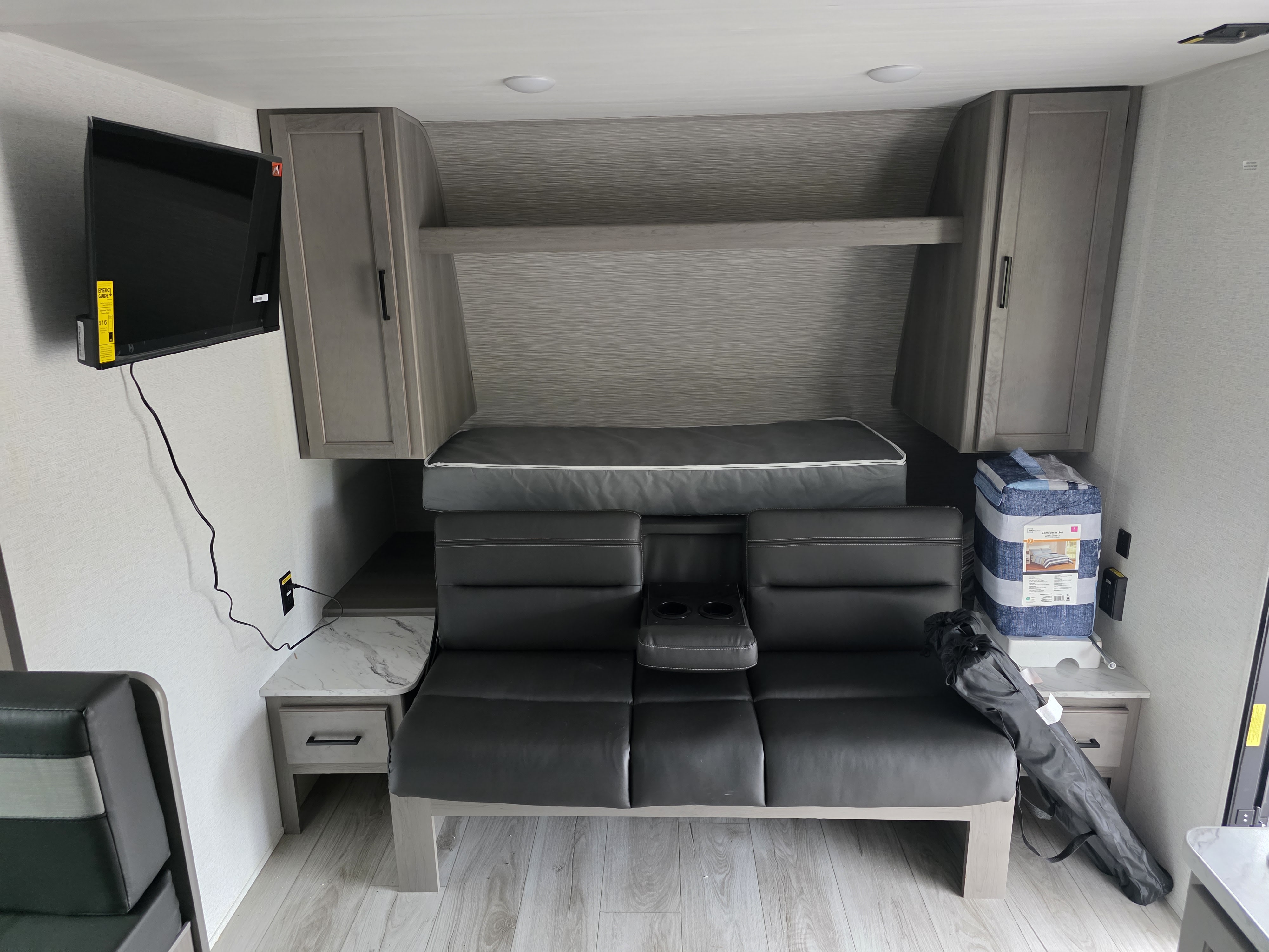 This RV rental features a flexible layout with a convertible sofa bed, mounted TV, and ample overhead storage.. Keystone RV Hideout 2025