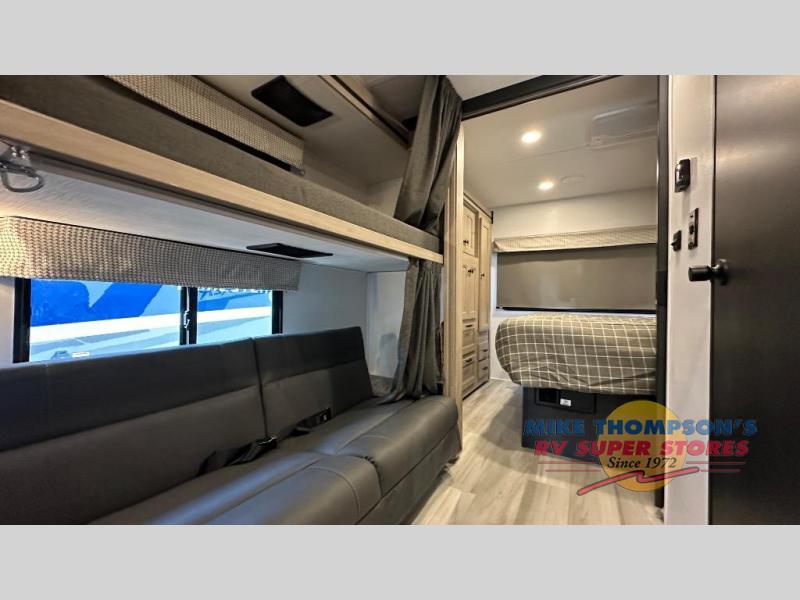 RV rental interior showcasing bunk beds, sofa seating, and a comfortable master bed area. Ideal for travel & family stays.. Forest River Sunseeker LE 2025