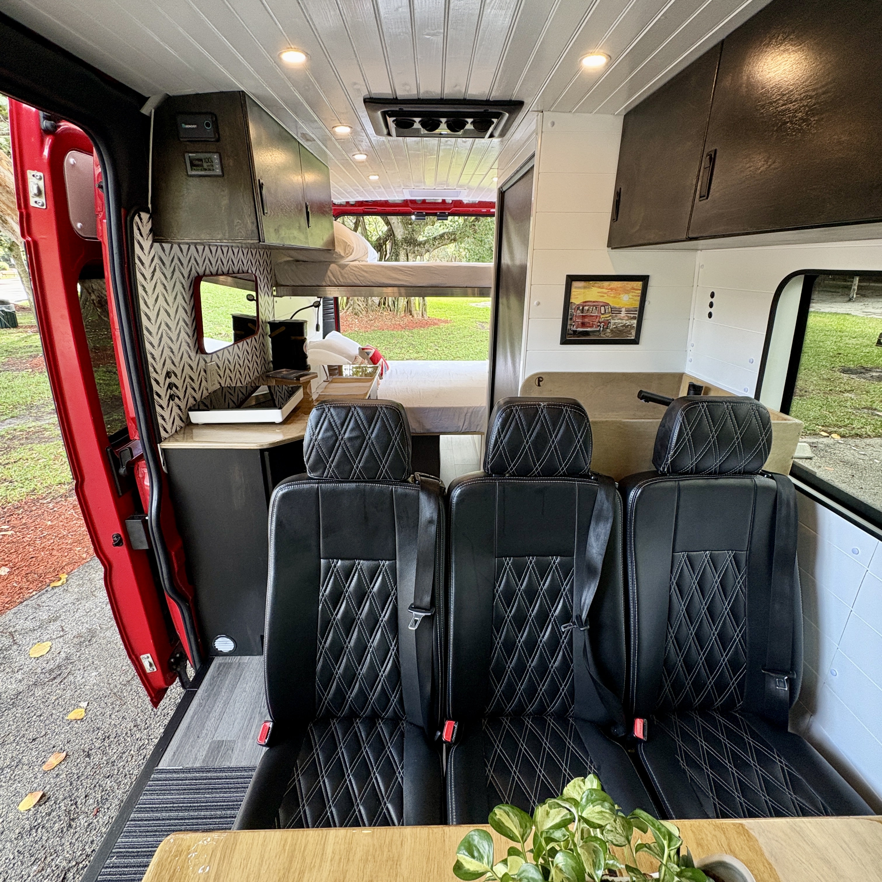 Experience comfort in this RV rental's custom interior: seating for three, a kitchen, and a sleeping area. Ideal for camping & travel.. Ram Promaster 3500 2019