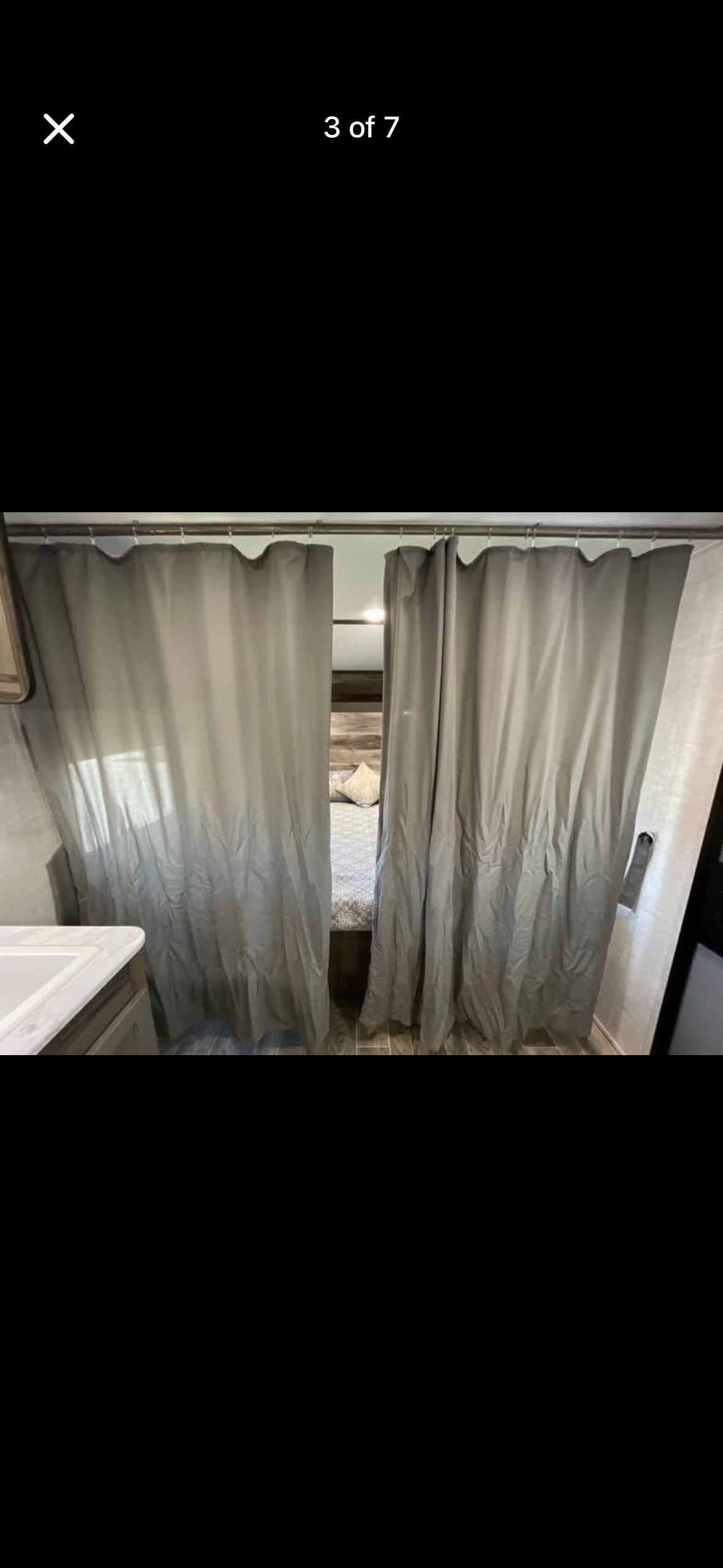 RV rental interior: privacy curtains open to a bedroom with a bed, next to a sink.. Gulf Stream Enlighten 2021
