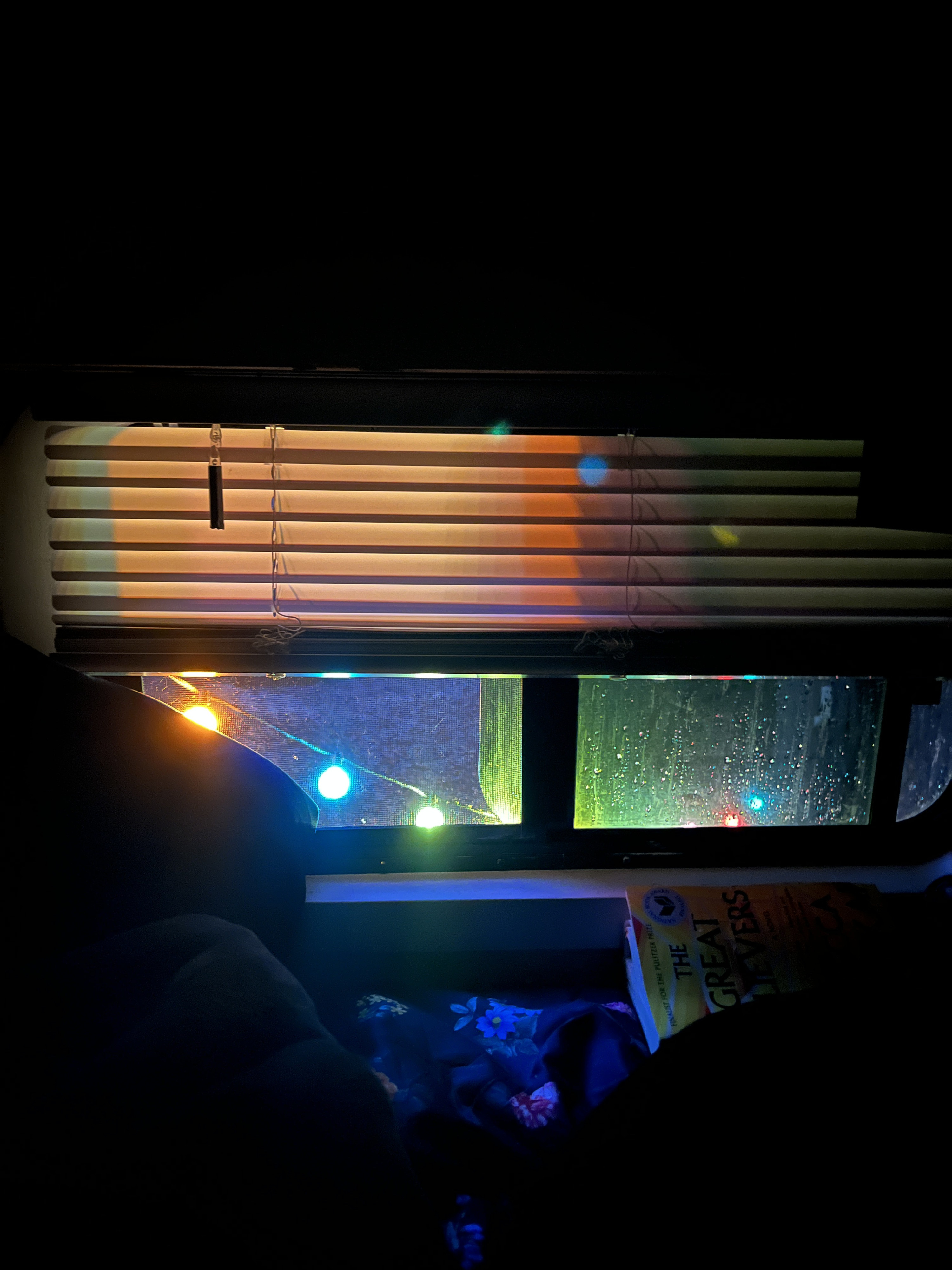 Cozy RV rental interior at night. Rain on the window, colorful string lights, and a book waiting to be read.. Ford Custom Transit 2019