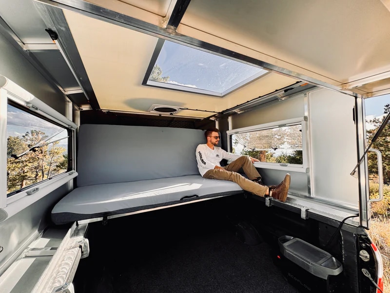 Relax in this RV rental truck camper with panoramic views & portable power. Ideal for outdoor adventures and comfortable stays.. Chevrolet Silverado 1500 Trail Boss 2020