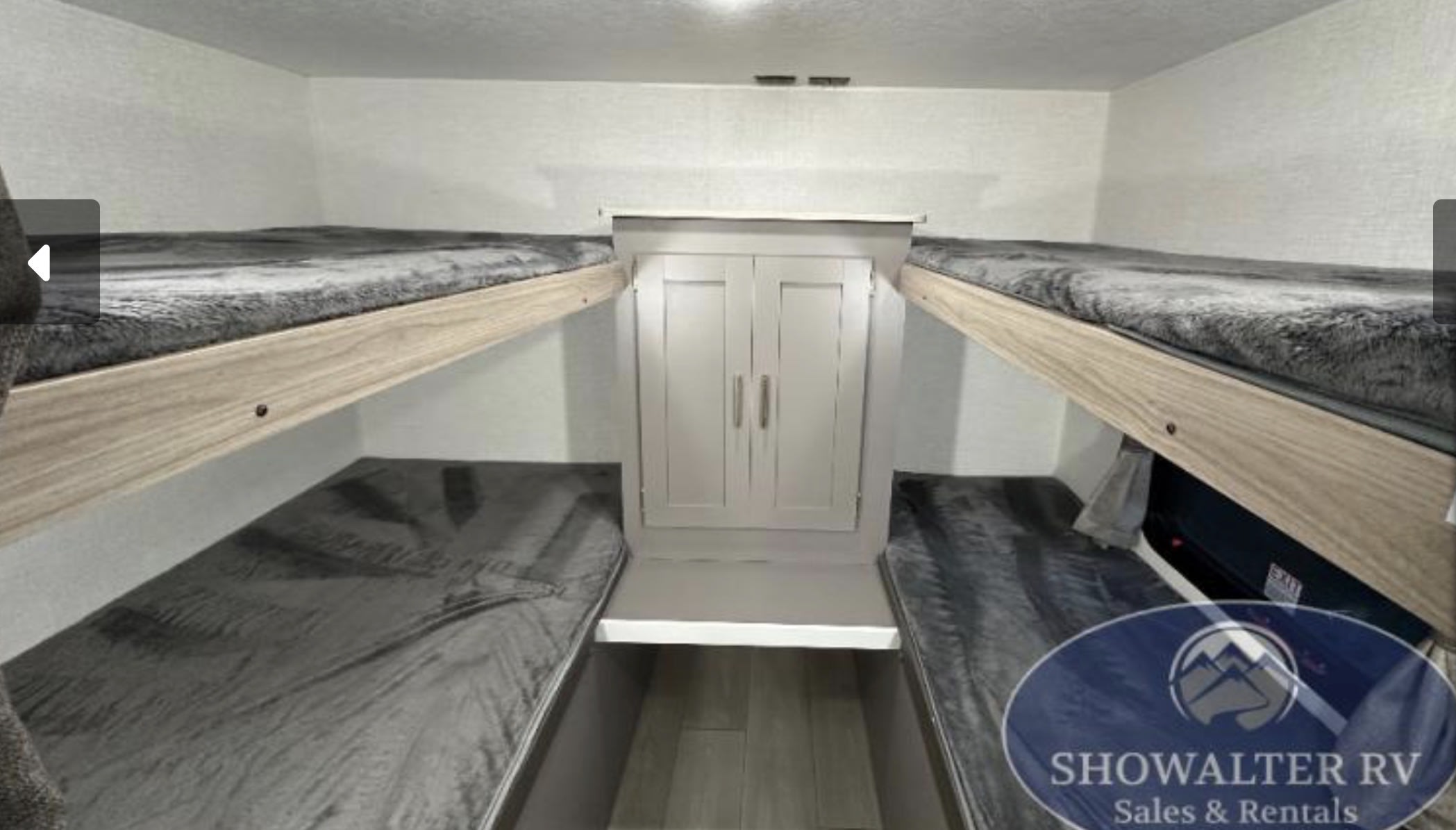 Cozy RV rental bunk room features four sleeping bunks & central wardrobe storage for family adventures.. KZ Sportsmen SE 2025