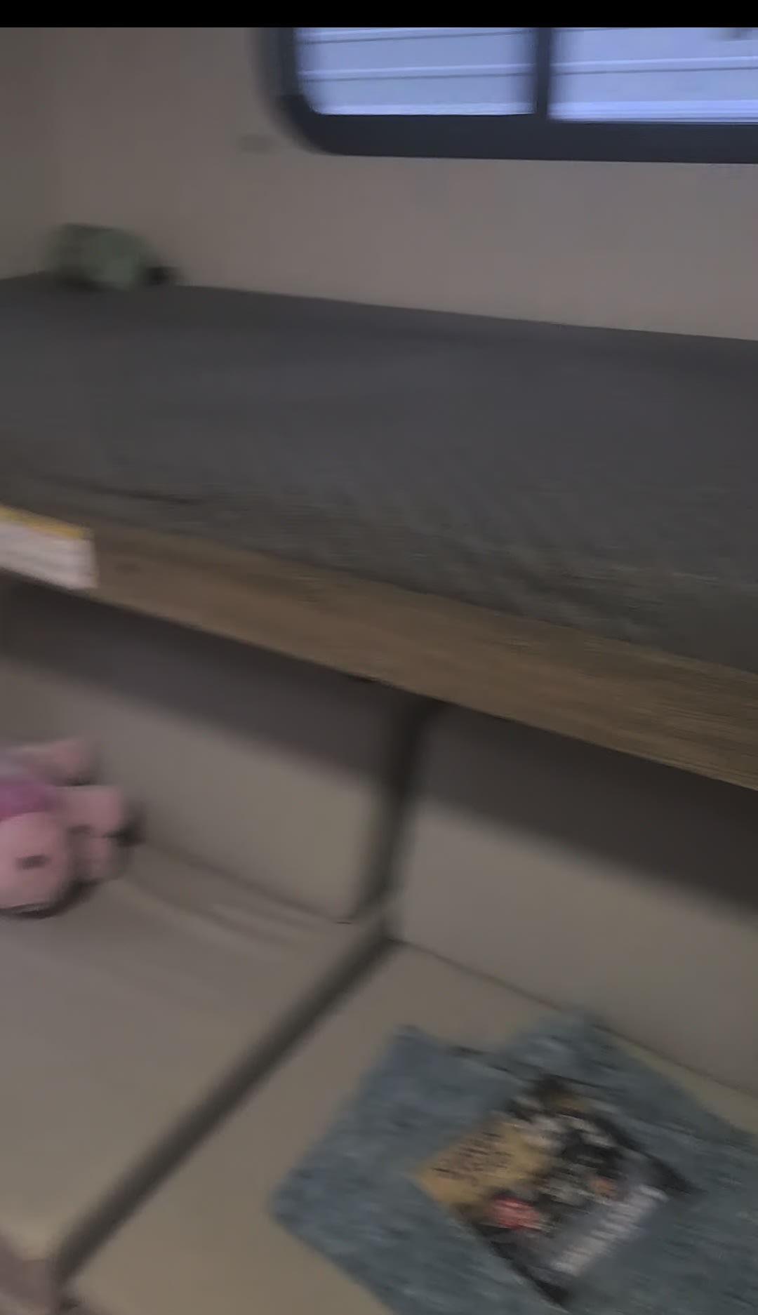 RV rental interior: bunk bed over sofa, window, blanket, pink stuffed animal. Cozy family space.. Eddie Bauer Eddie Bauer 2024