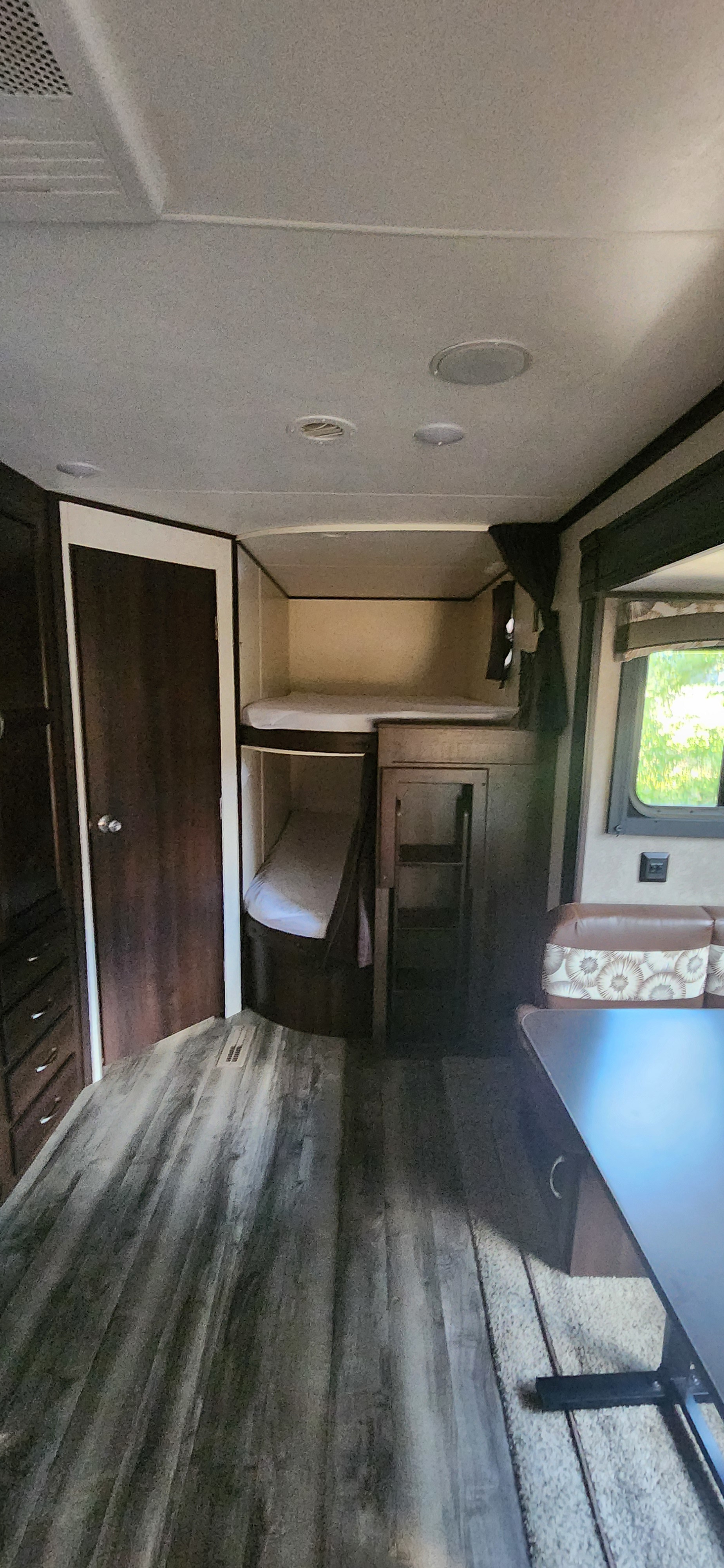 Explore this RV rental's cozy interior: bunk beds, dining area, and wood-grain floor. Perfect for family trips.. Jayco Jay Flight 2018