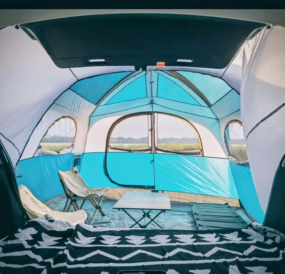 Inside a comfy tent attached to a vehicle, featuring chairs, table, & scenic views. An ideal escape complementing any RV rental adventure.. Dodge B Van 2008