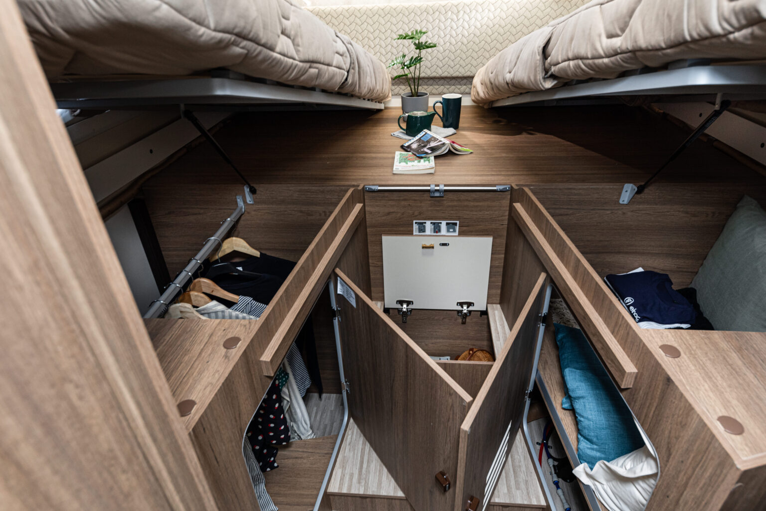 Clever rv rental storage: Under-bed compartments, hanging wardrobes & built-in cabinets keep this cozy mobile interior organized.. ELNAGH BARON 573 2026