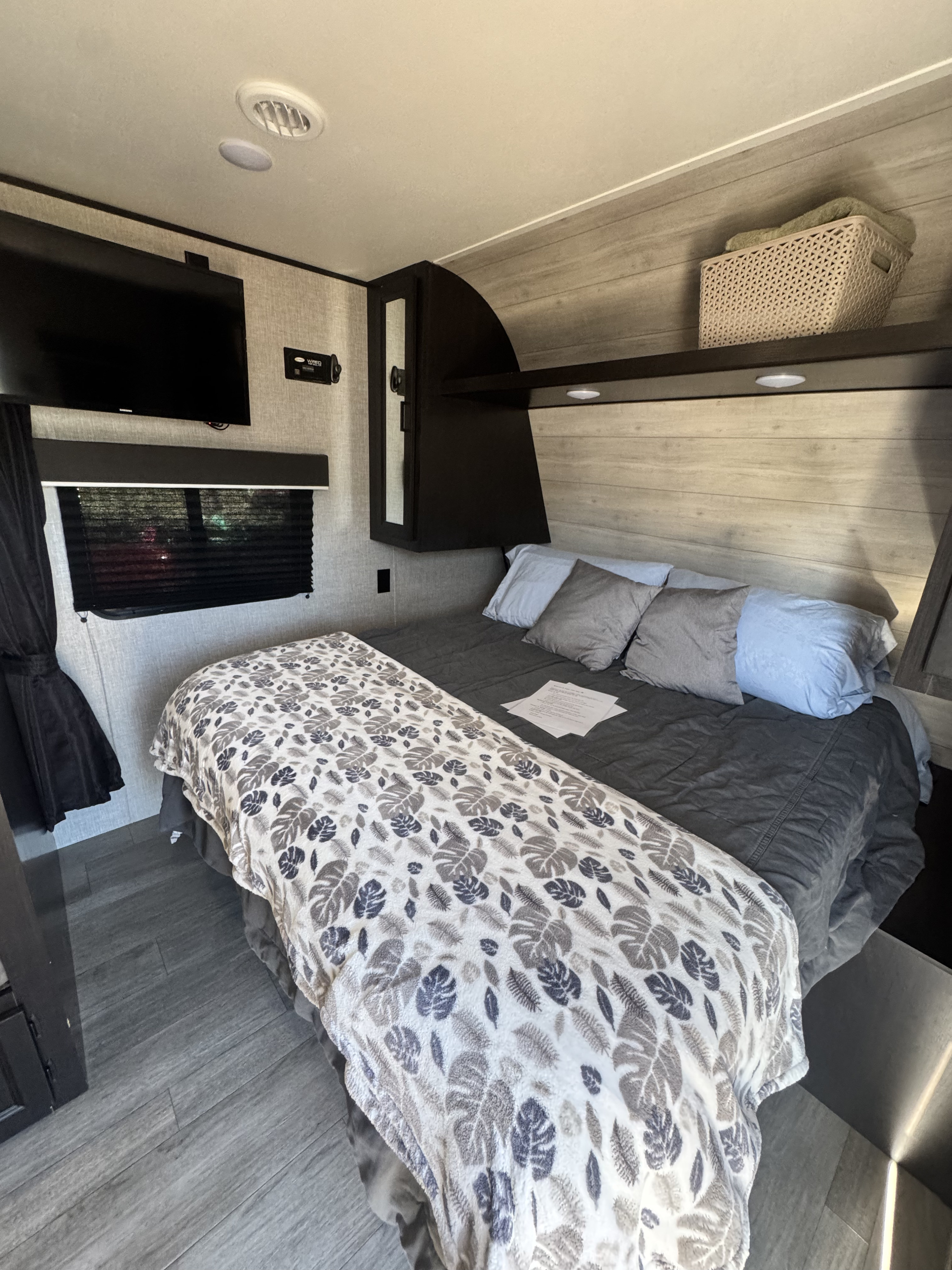 Cozy RV rental bedroom with a comfy bed, TV, window, and wood-look flooring. Ideal for a relaxing trip.. Jayco Jay Flight SLX 2021