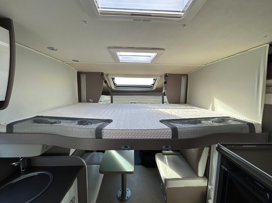 RV rental: View inside a modern motorhome featuring a drop-down bed over the dinette & kitchen area.. BURSTNER Lyséo TD 736 Privilège 2023
