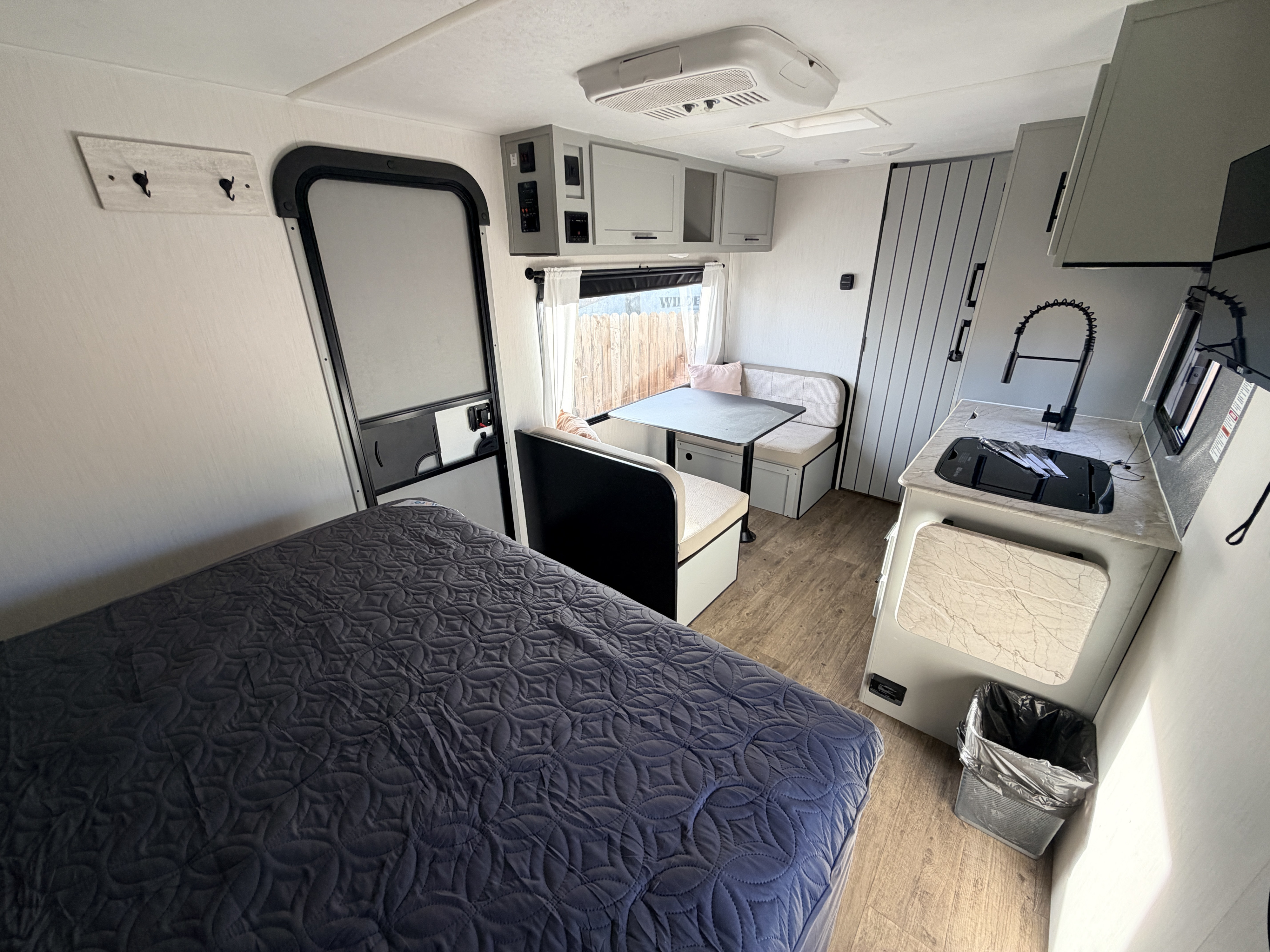 Experience comfort in this rv rental. Features a bedroom, kitchen, and dinette in a compact, modern interior.. Forest River Vibe 2021