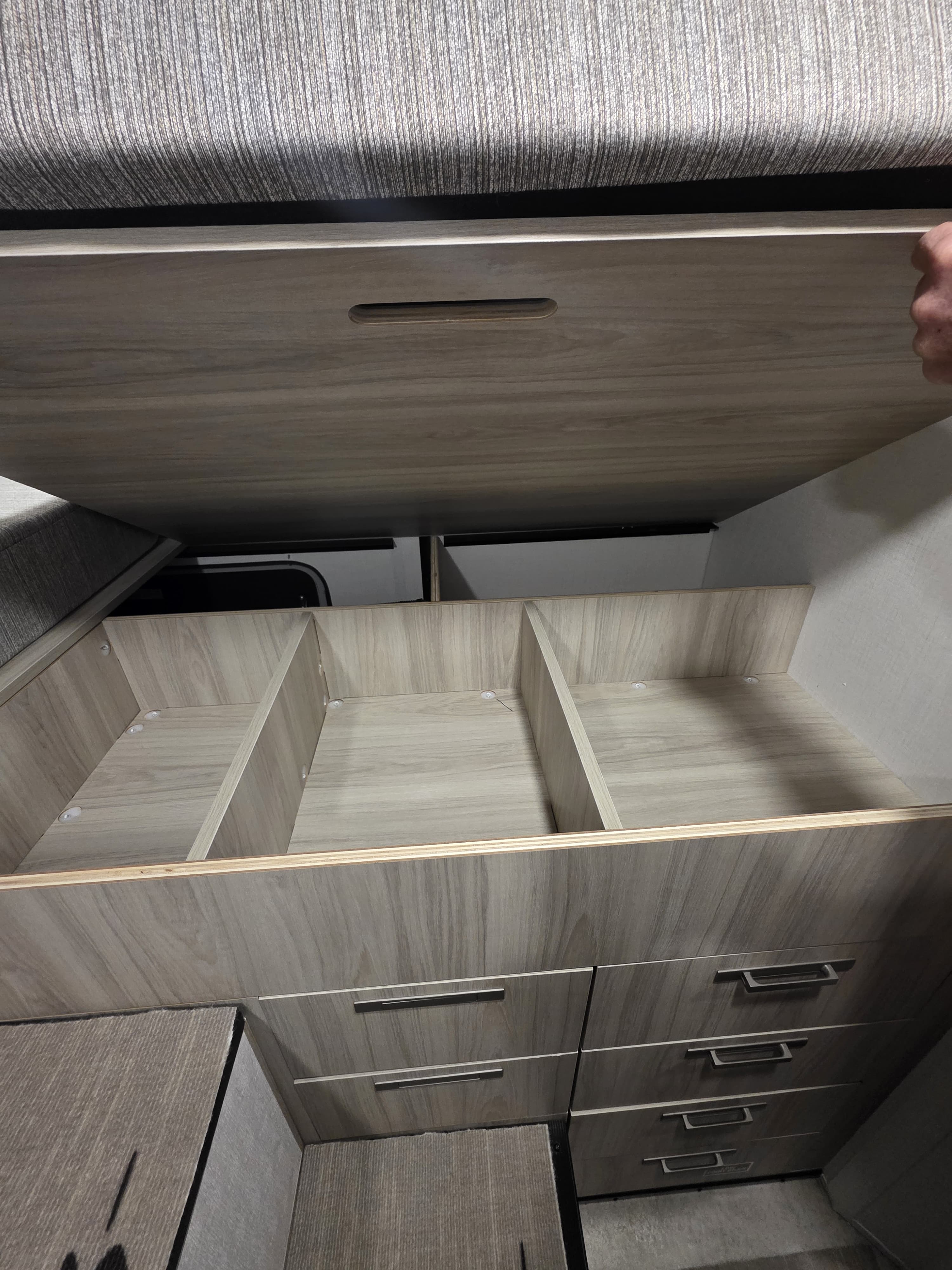 Spacious under-bed storage with divided compartments and multiple drawers in an RV rental, perfect for organized packing.. Forest River Coachmen Cross Trail EV 2026