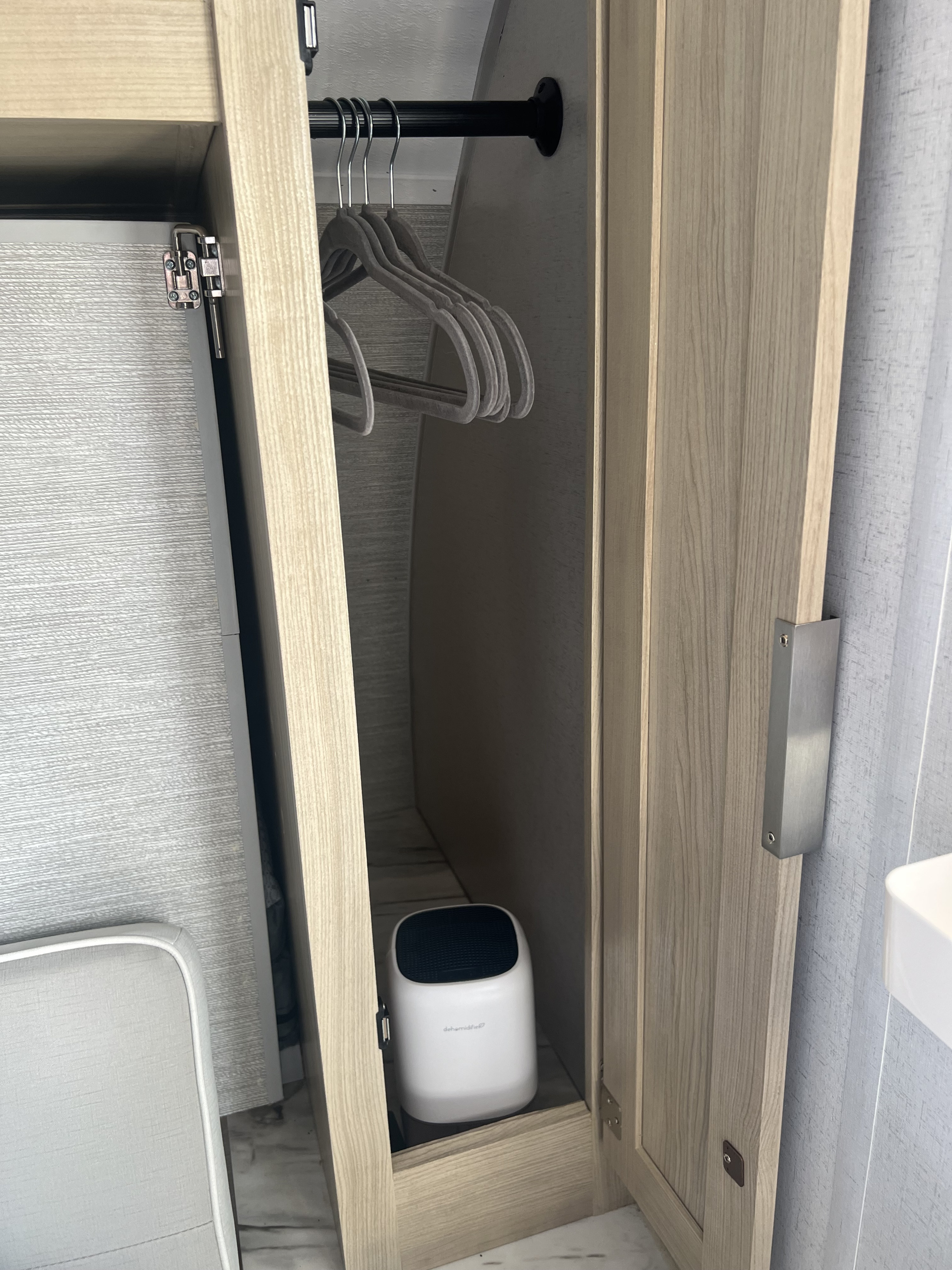 RV rental closet with hangers & dehumidifier. Compact storage for clothes & moisture control.. Forest River Salem FSX 2023