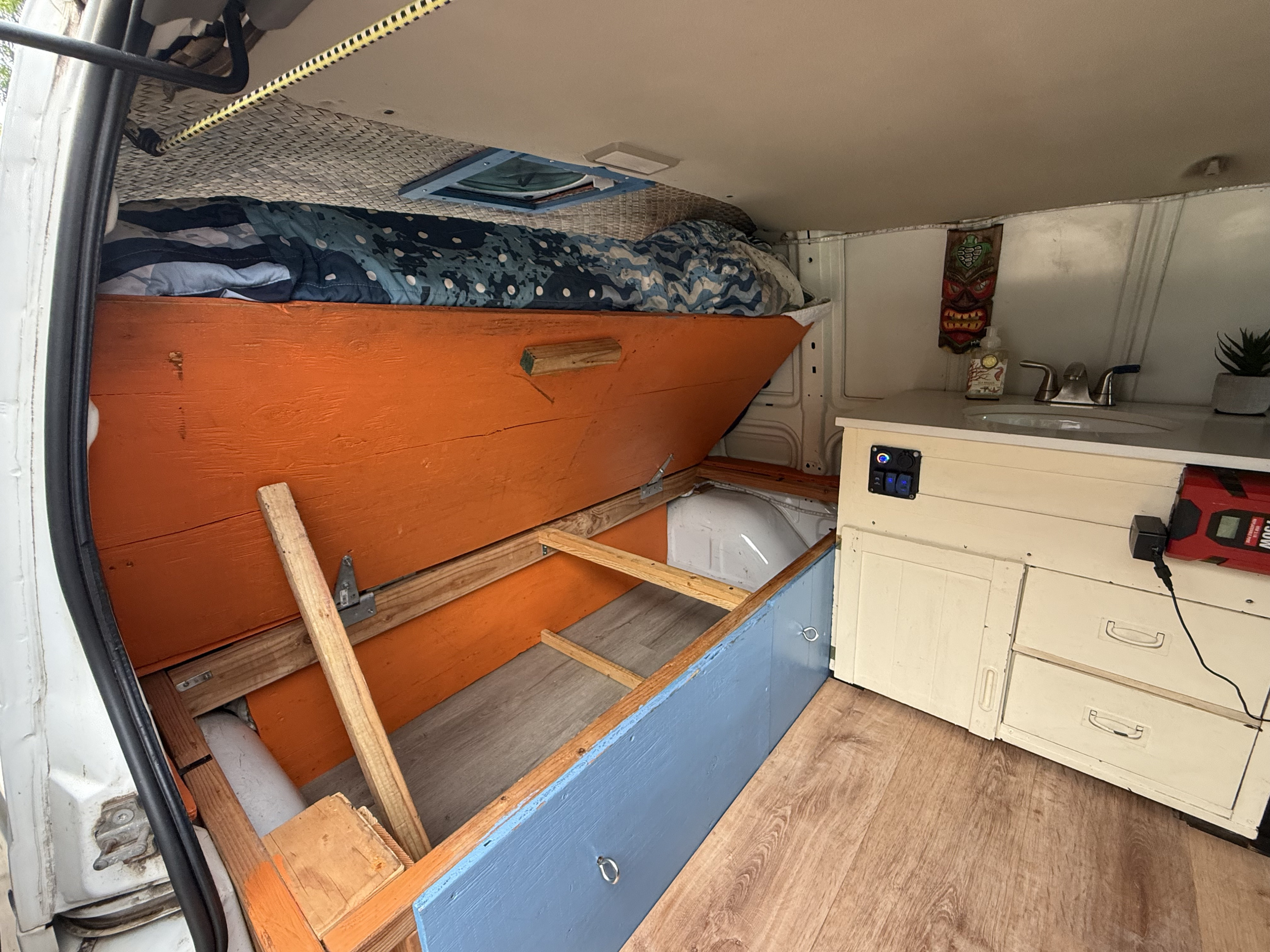 Explore this RV rental's cozy custom interior, featuring a convertible bed, storage, sink, and power for off-grid adventures.. Chevrolet Other 2005