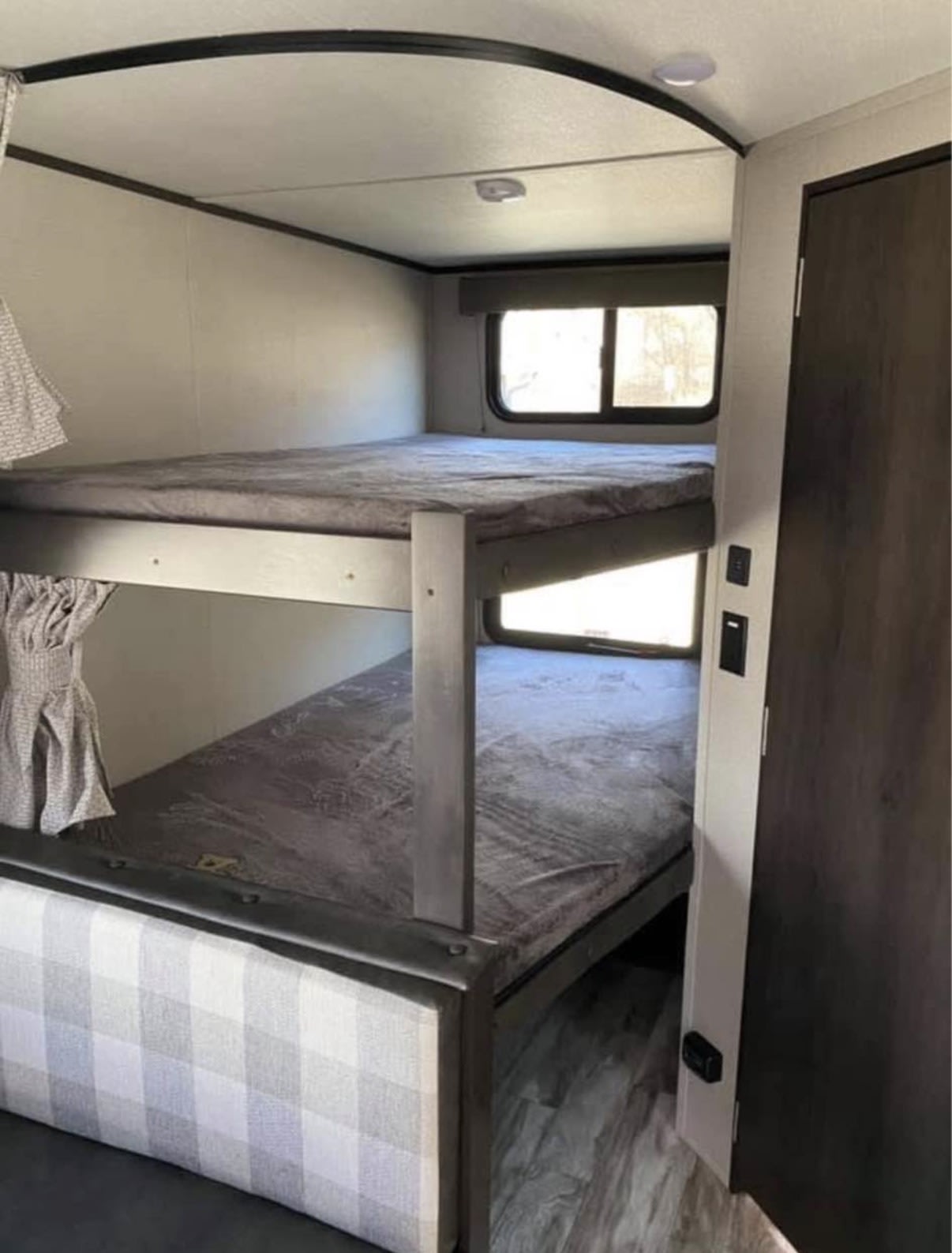 Rv rental interior: two comfortable bunk beds with gray bedding and windows, providing a cozy sleeping area.. Grand Design Transcend Xplor 2021