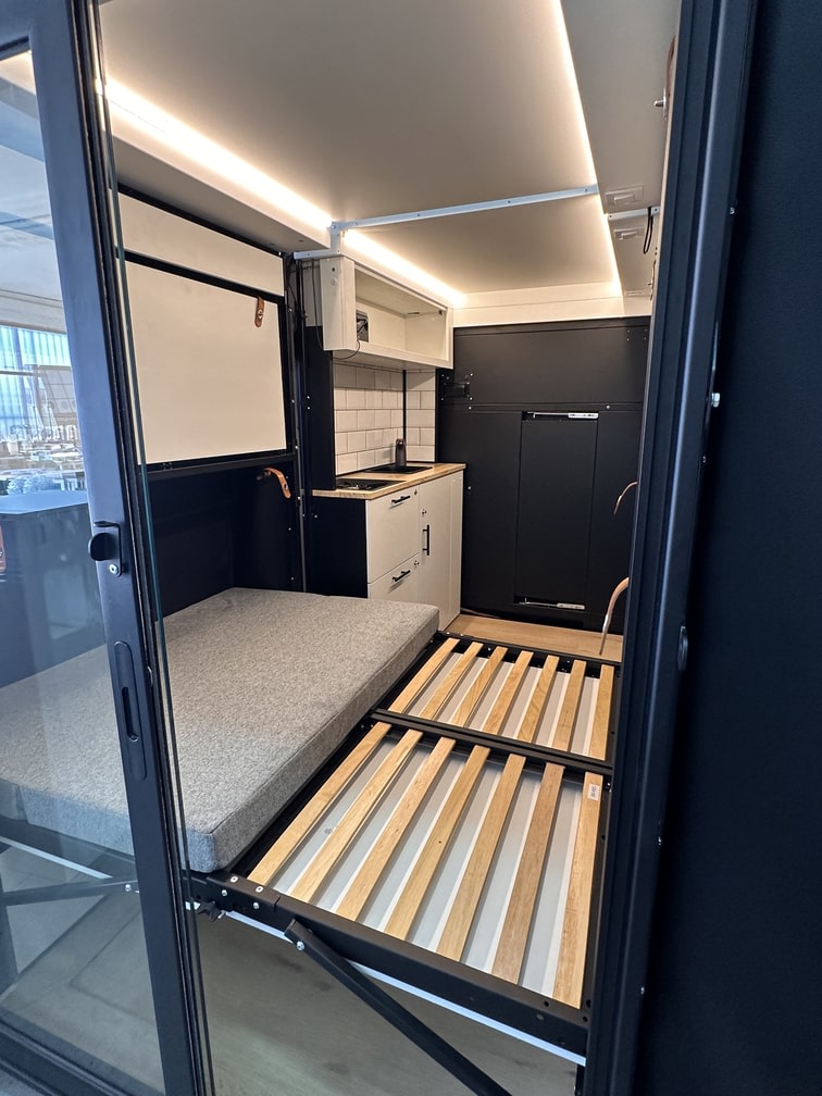 Modern rv rental: space-saving interior with a compact kitchen, built-in lighting, and a clever fold-out bed.. Mercedes-Benz Sprinter 2022