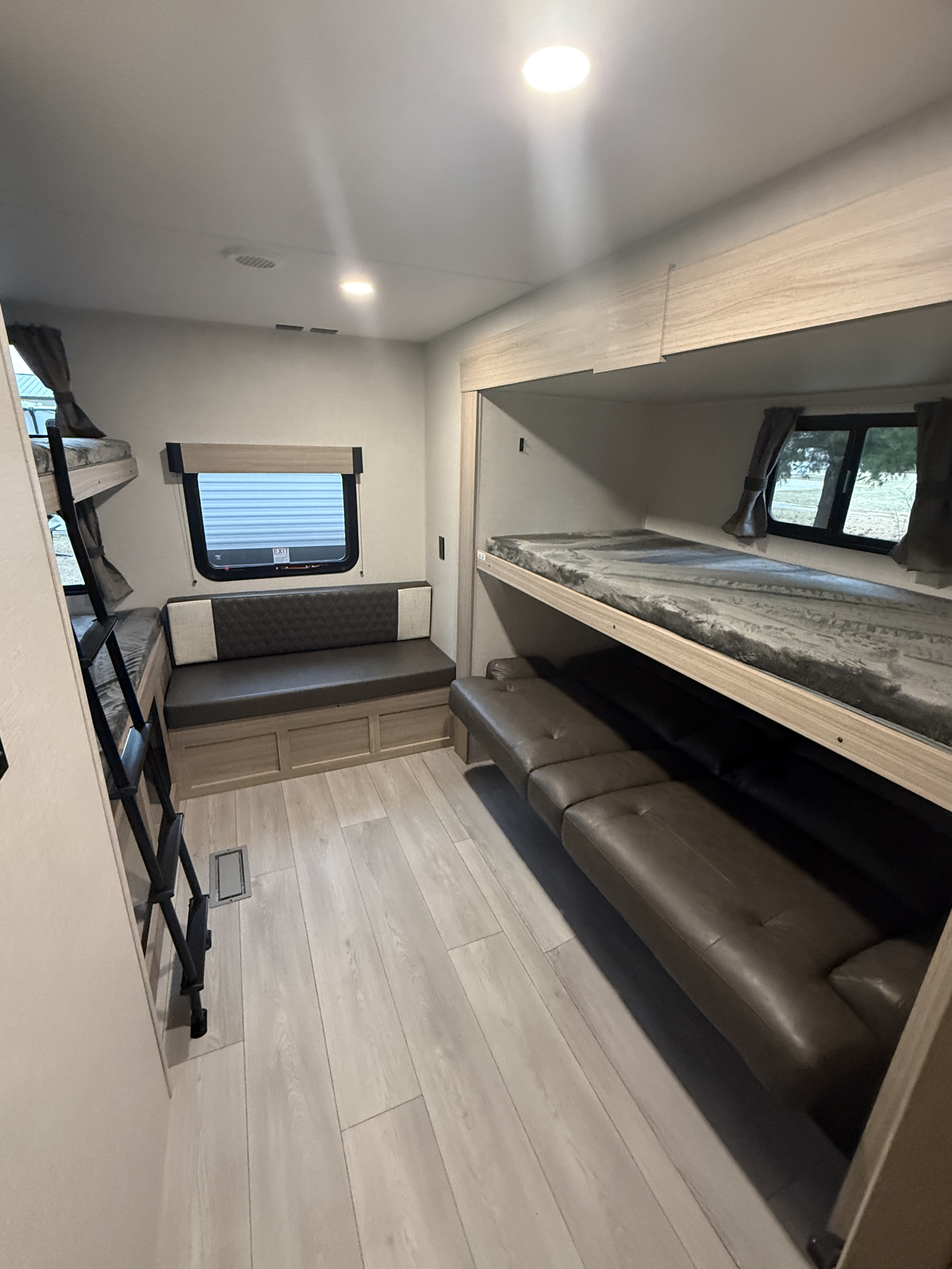 Explore this RV rental's bunkhouse, featuring bunk beds, a dinette, and an extra sofa for comfortable family trips.. KZ Sportsmen SE 2026