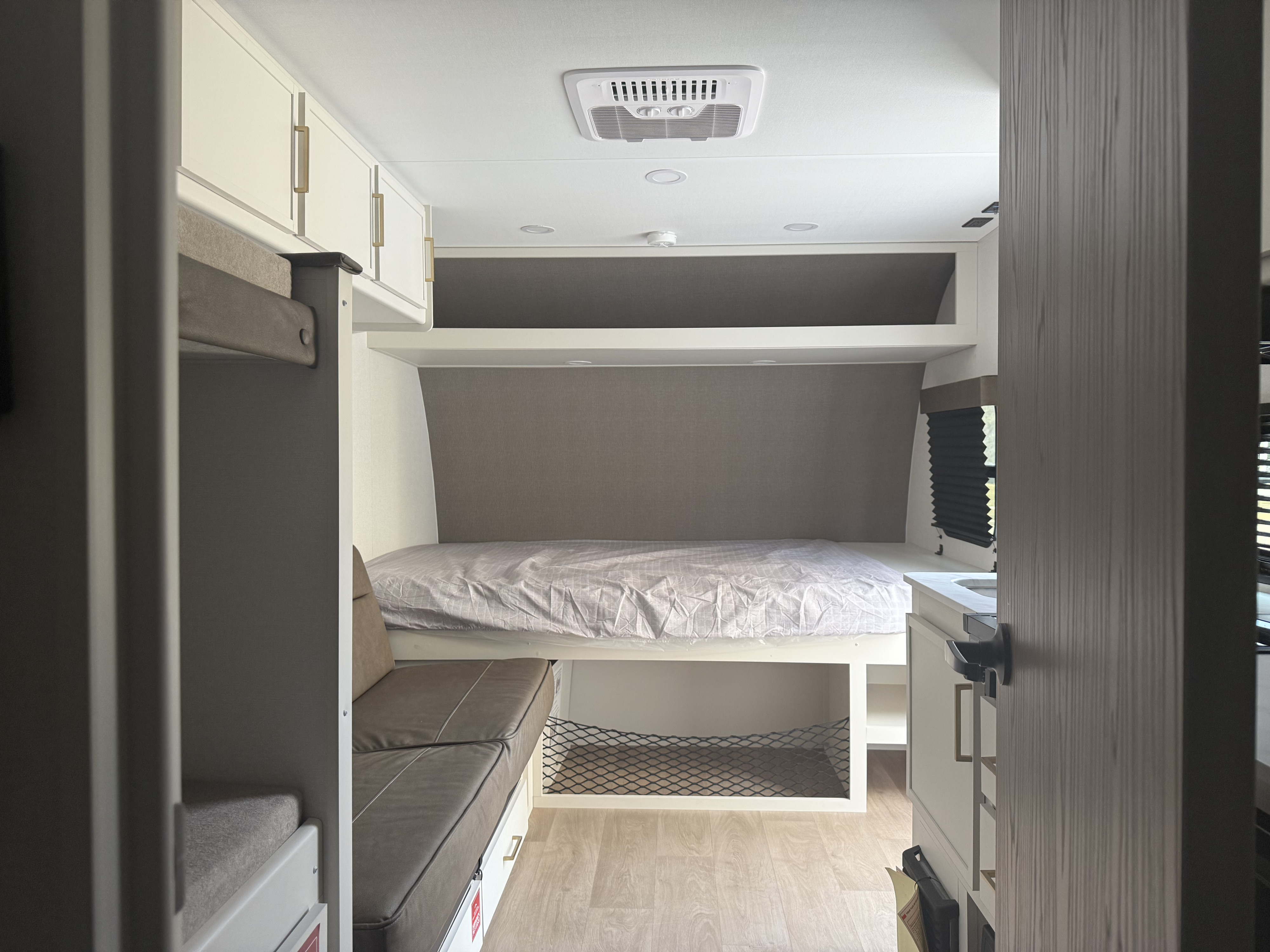 Explore this modern rv rental interior, featuring bunk beds, a main sleeping area, and smart storage for comfortable travel.. Transcend One 151BH 2026