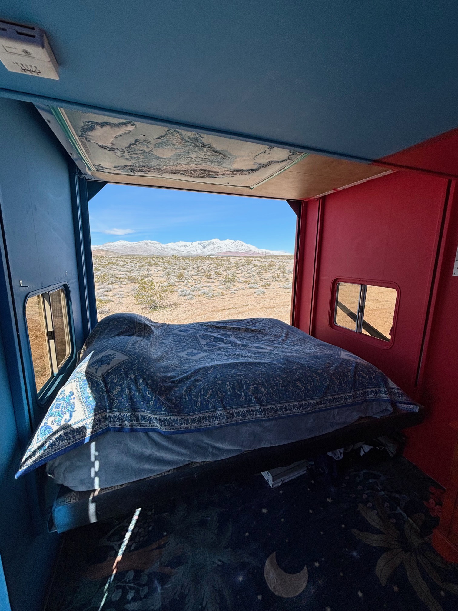 Cozy RV rental bedroom with a view! Enjoy desert landscapes and snow-capped mountains from your unique travel bed.. Keystone Raptor 2026
