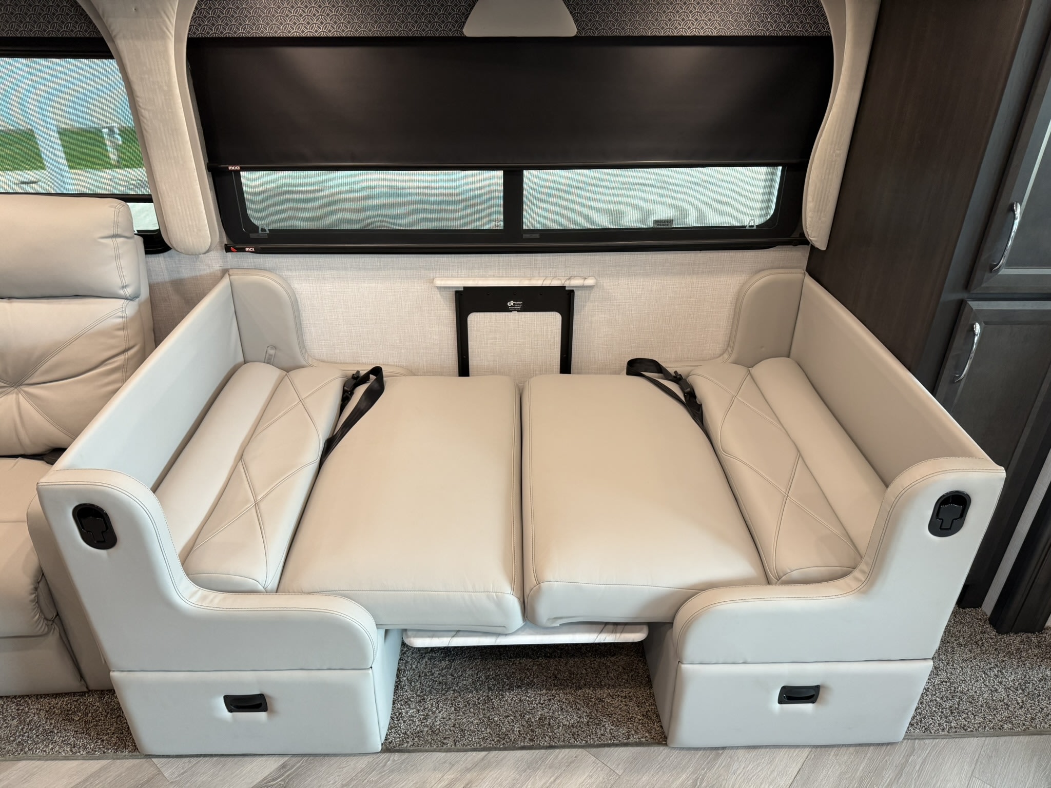 RV rental: Bright, convertible dinette in a modern RV motorhome, easily transforming from seating with seatbelts to a comfortable bed.. Bounder Bounder Motorhome 2024