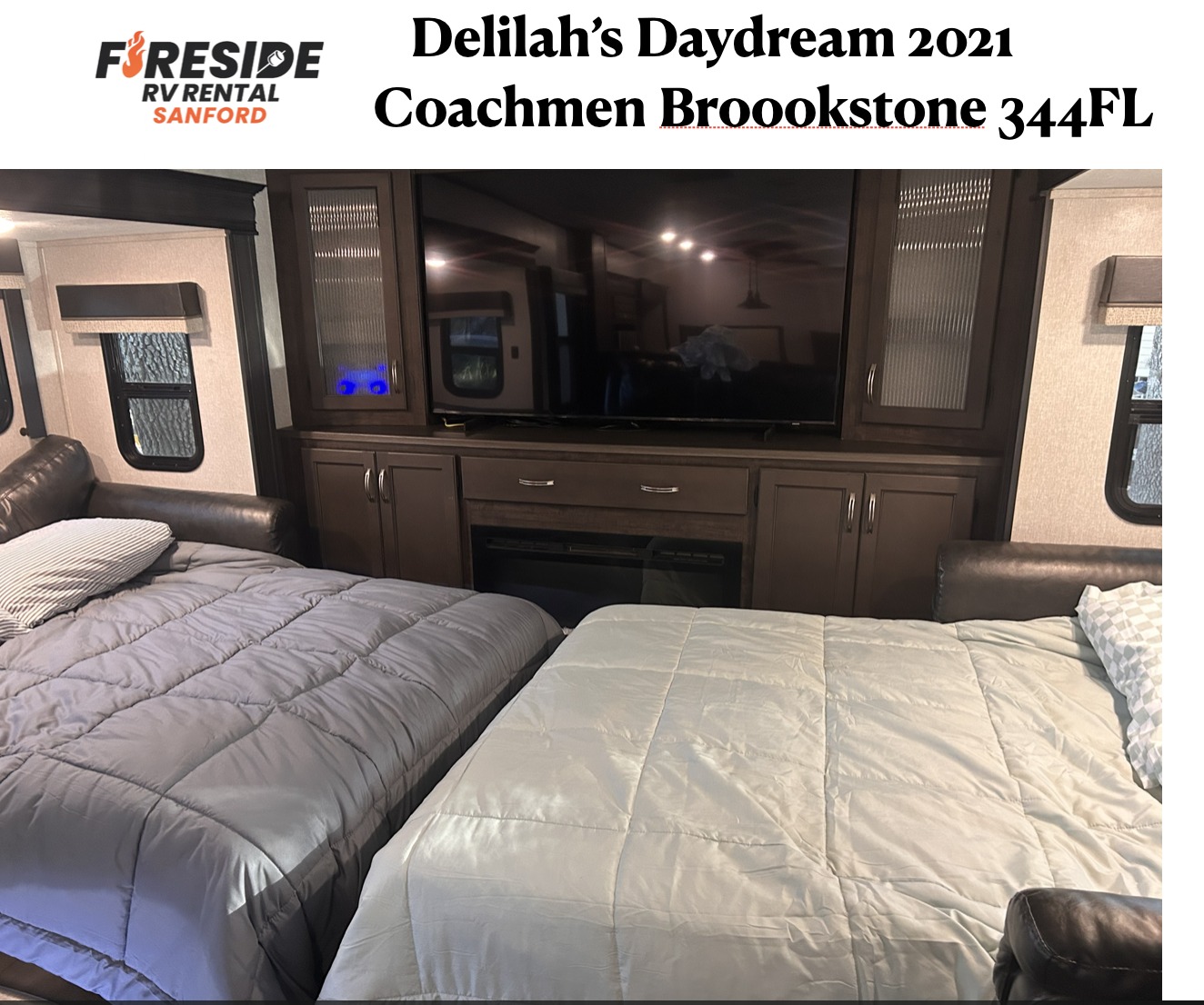 Delilah's Daydream RV rental living area with two comfortable beds, a TV, and fireplace for a cozy stay.. Coachmen Brookstone 2021
