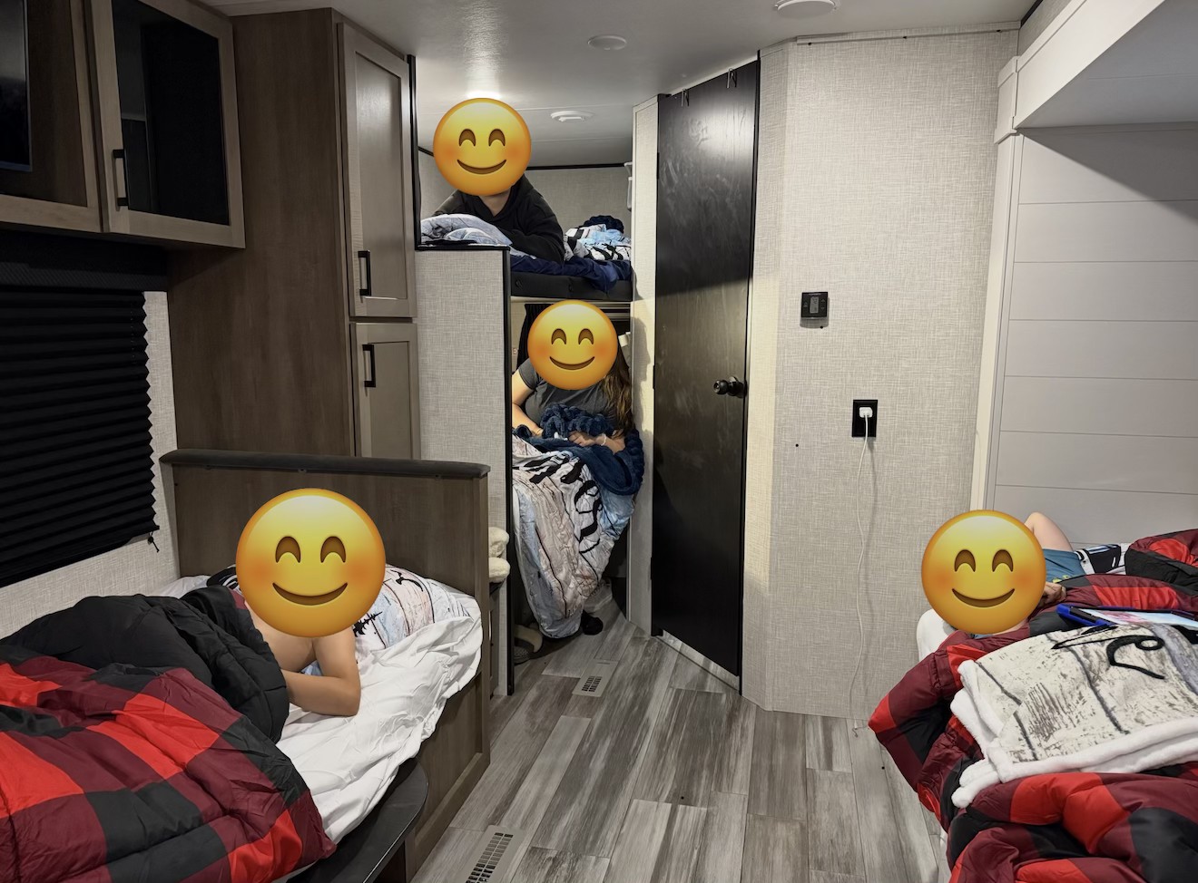Inside a comfortable RV rental, showing people relaxing in bunk beds and a main bed. Perfect for family trips!. Jayco Jay Flight SLX 2025