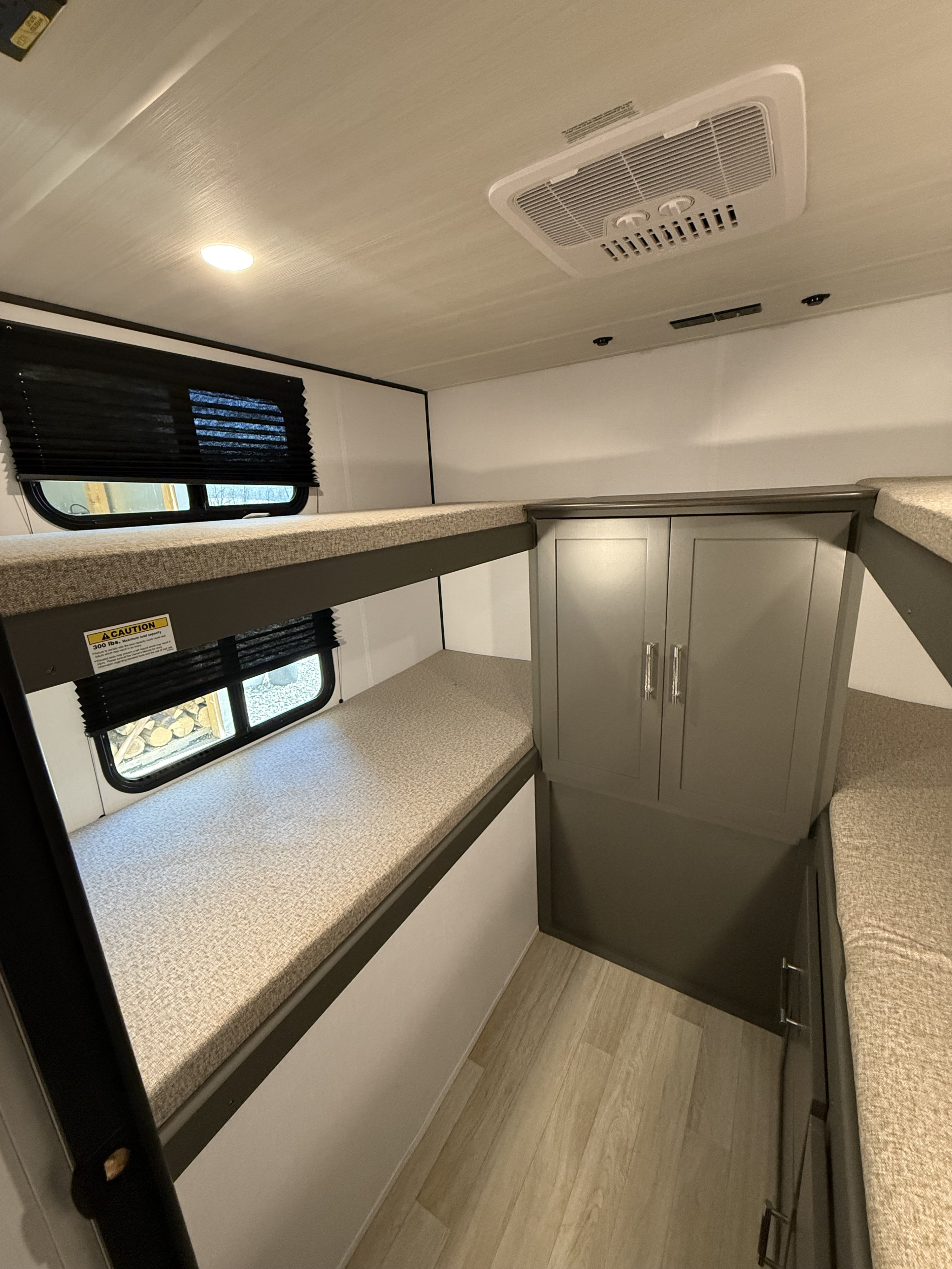 RV rental bunk beds, storage cabinet, and AC unit provide comfortable lodging for guests.. Keystone Bullet 2026