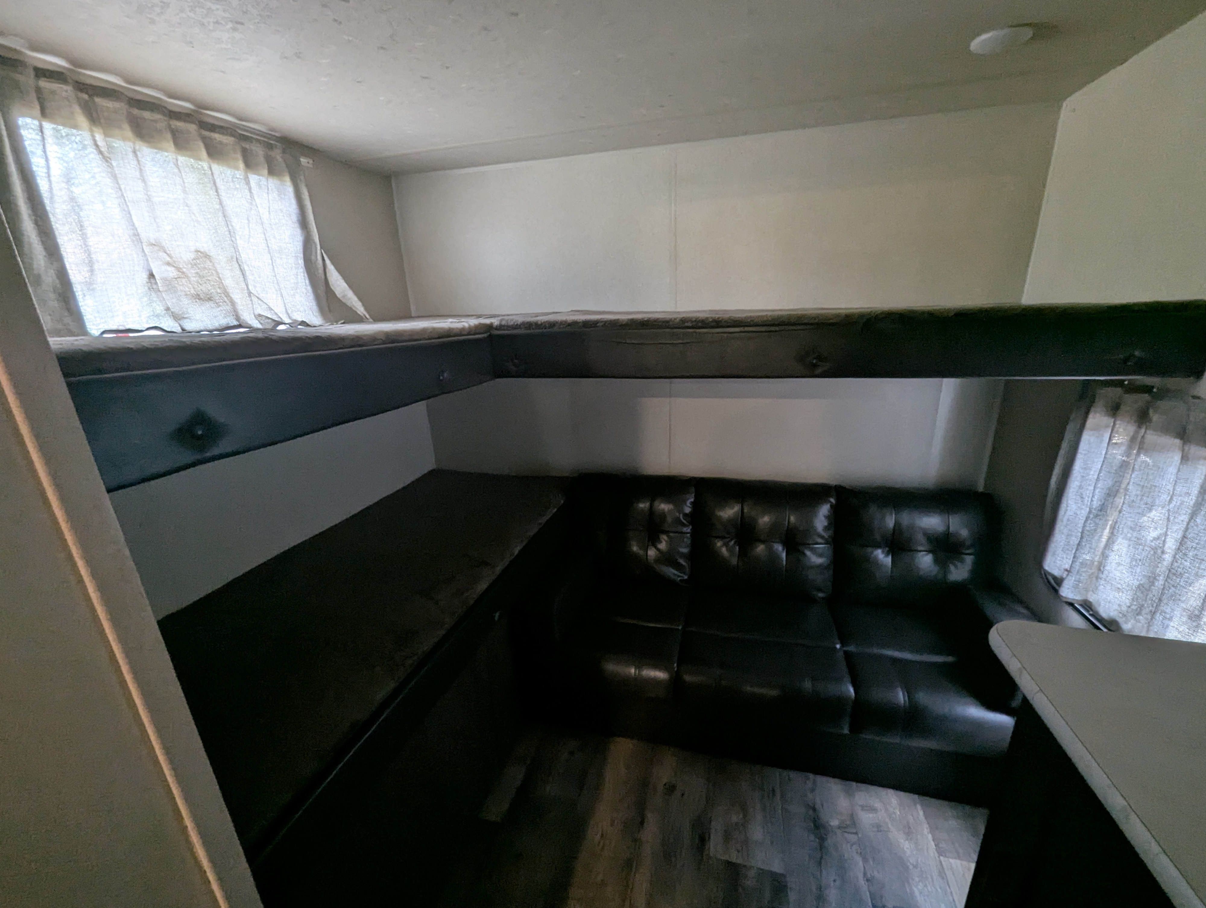 RV rental interior: L-shaped bunk bed, convertible sofa, dinette, and windows. Compact, functional living space.. Forest River Salem Cruise Lite 2018