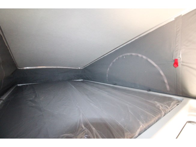 RV rental pop-top interior: a clean sleeping area with mattress covered in protective plastic, ideal for camper travel.. Winnebago Other 2022