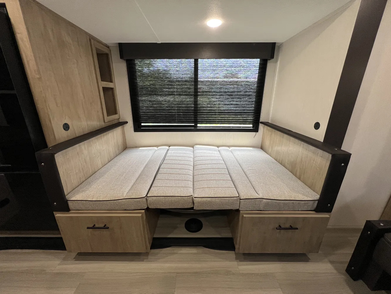 This rv rental features a cozy interior with a dinette transformed into a bed, offering comfort and under-bed storage.. Forest River Campsite Reserve 2026