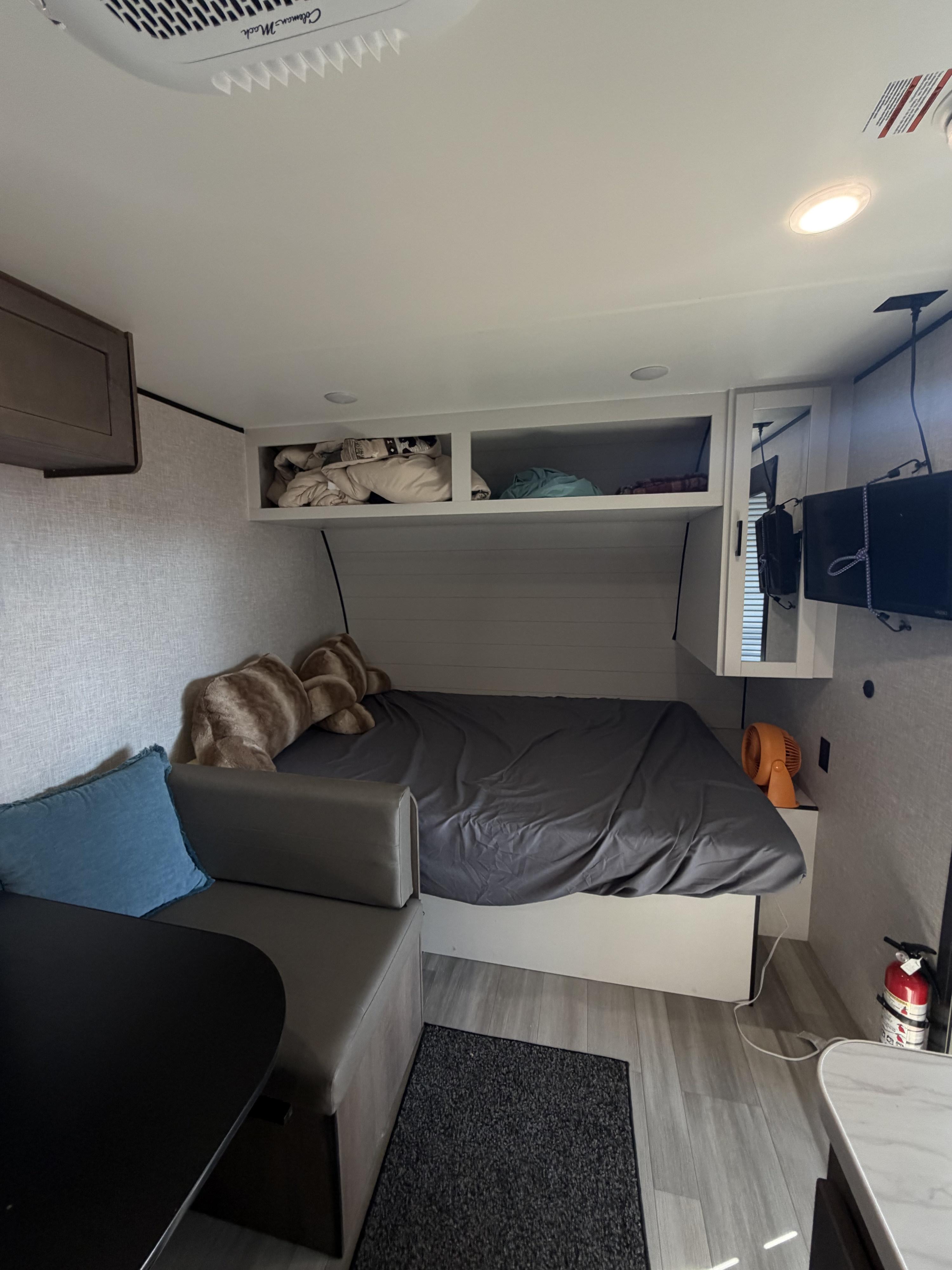 RV rental interior: A cozy bedroom with overhead storage, a dinette, and a TV, providing a compact, comfortable living space.. Starcraft AR One 2026