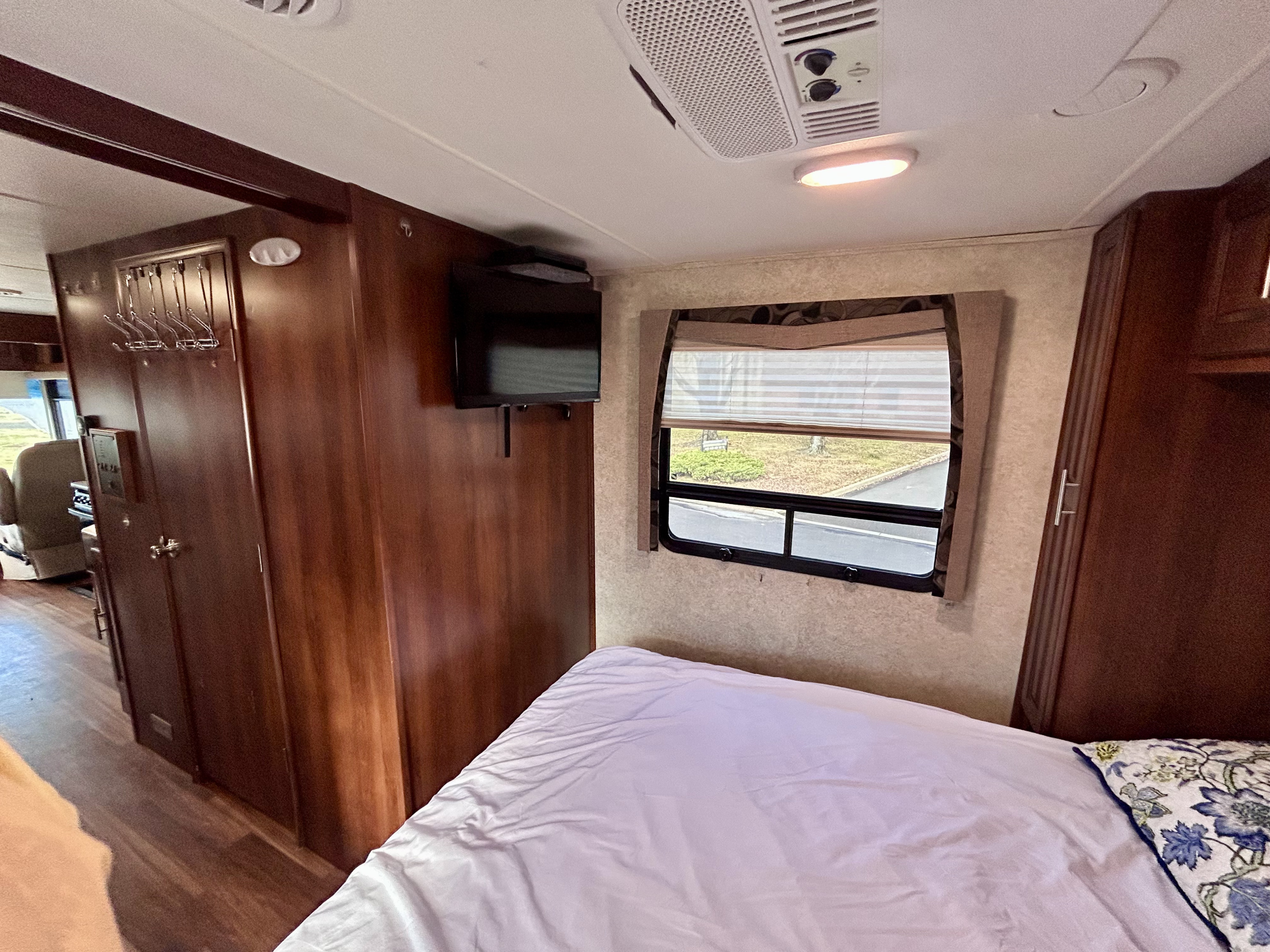 RV rental bedroom interior: comfortable bed, window with view, wall-mounted TV, and ample storage. Ideal for travelers.. Georgetown Georgetown Motorhome 2014