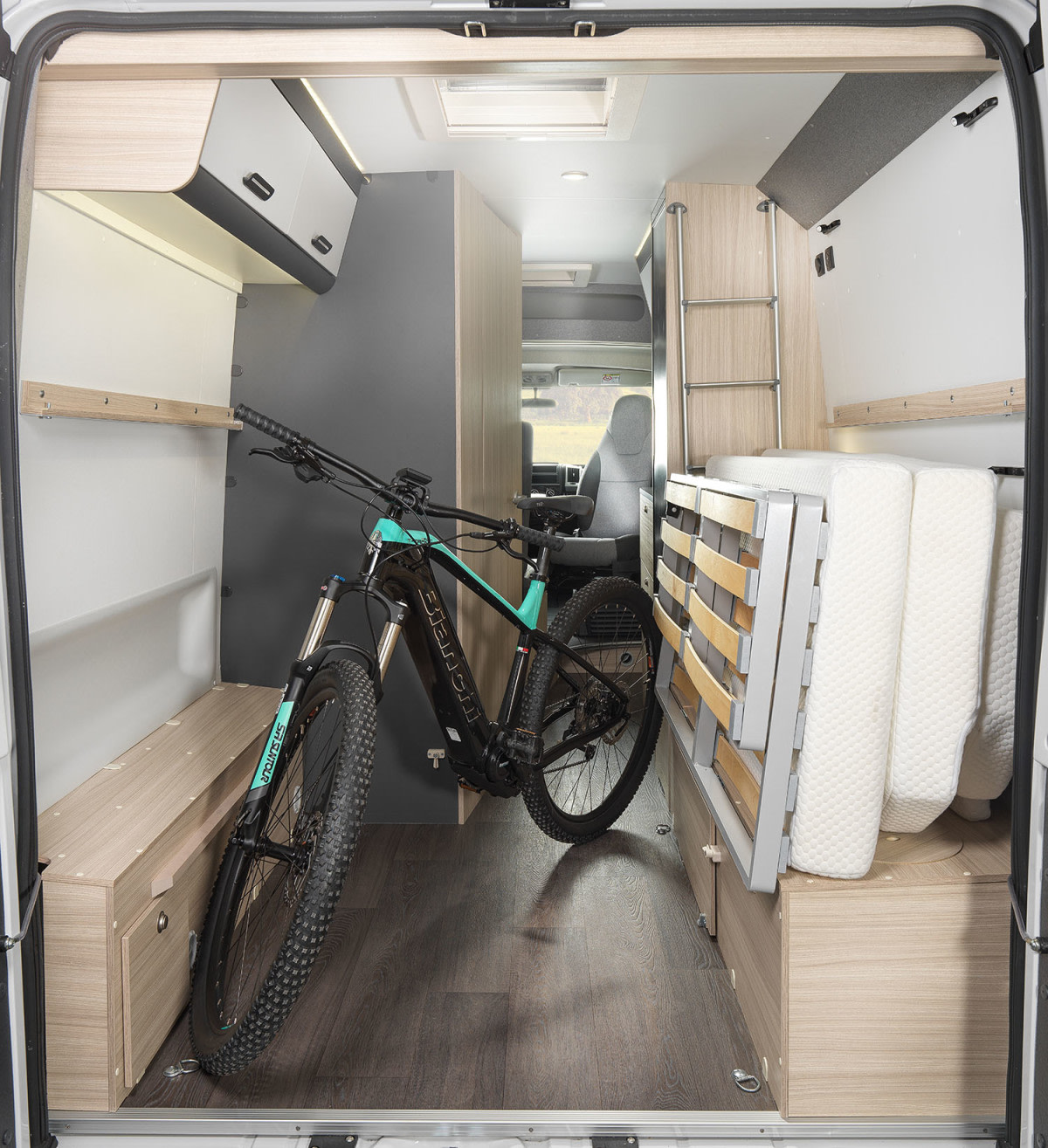 Versatile rv rental camper van interior: bike storage for adventure, fold-up bed, and ample space for gear.. SunLiving V 60 SP2026 2026