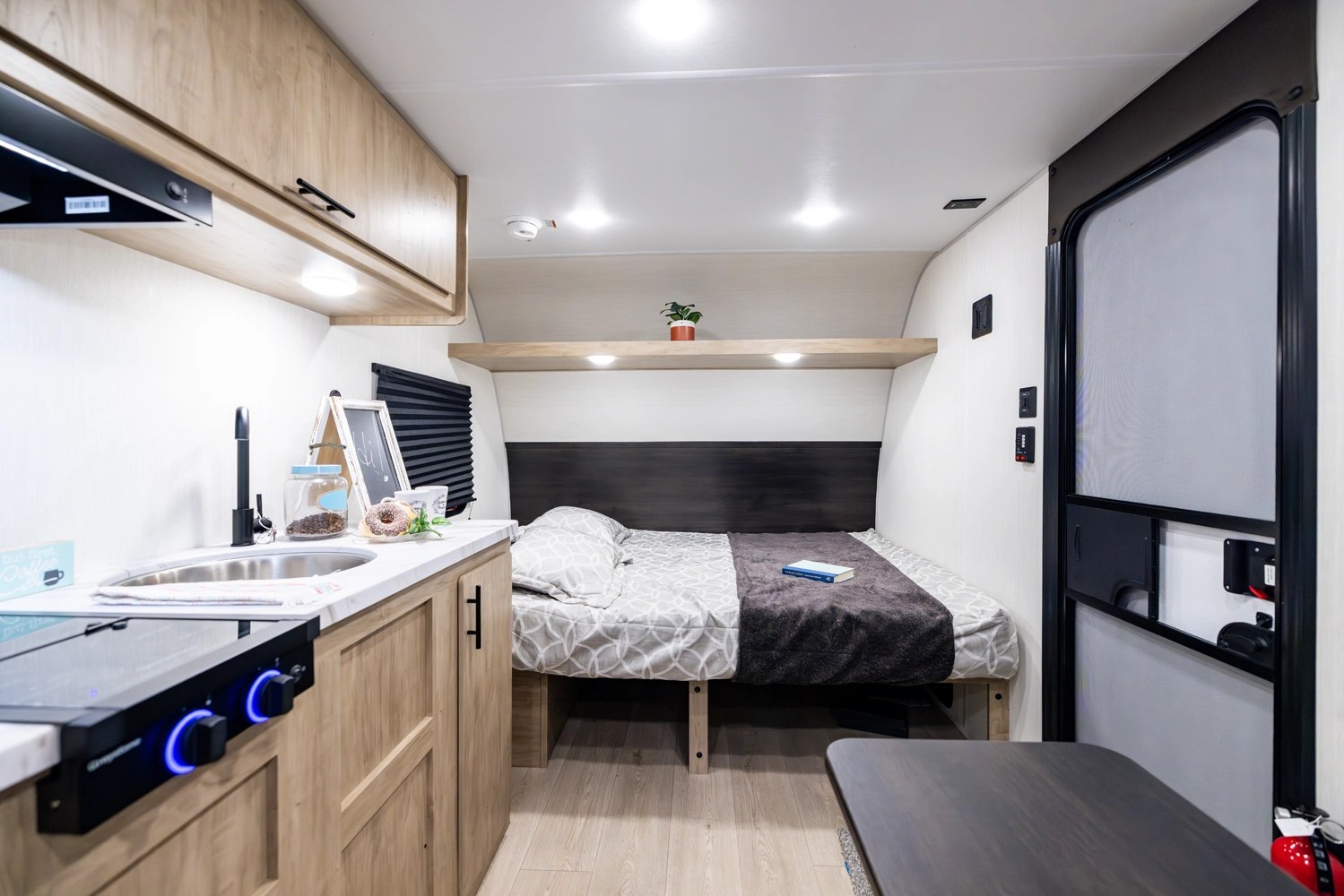 Experience a clean and cozy rv rental. This compact interior features a well-equipped kitchenette, a comfortable bed, and ample storage.. Forest River Wolf 17LP 2026