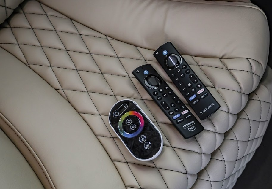 Enjoy entertainment in your RV rental! Three remotes (Fire TV, mood light) rest on comfortable quilted leather seating.. Mercedes Benz Executive Lounger by Legends Sprinter 3500XD 170 2023